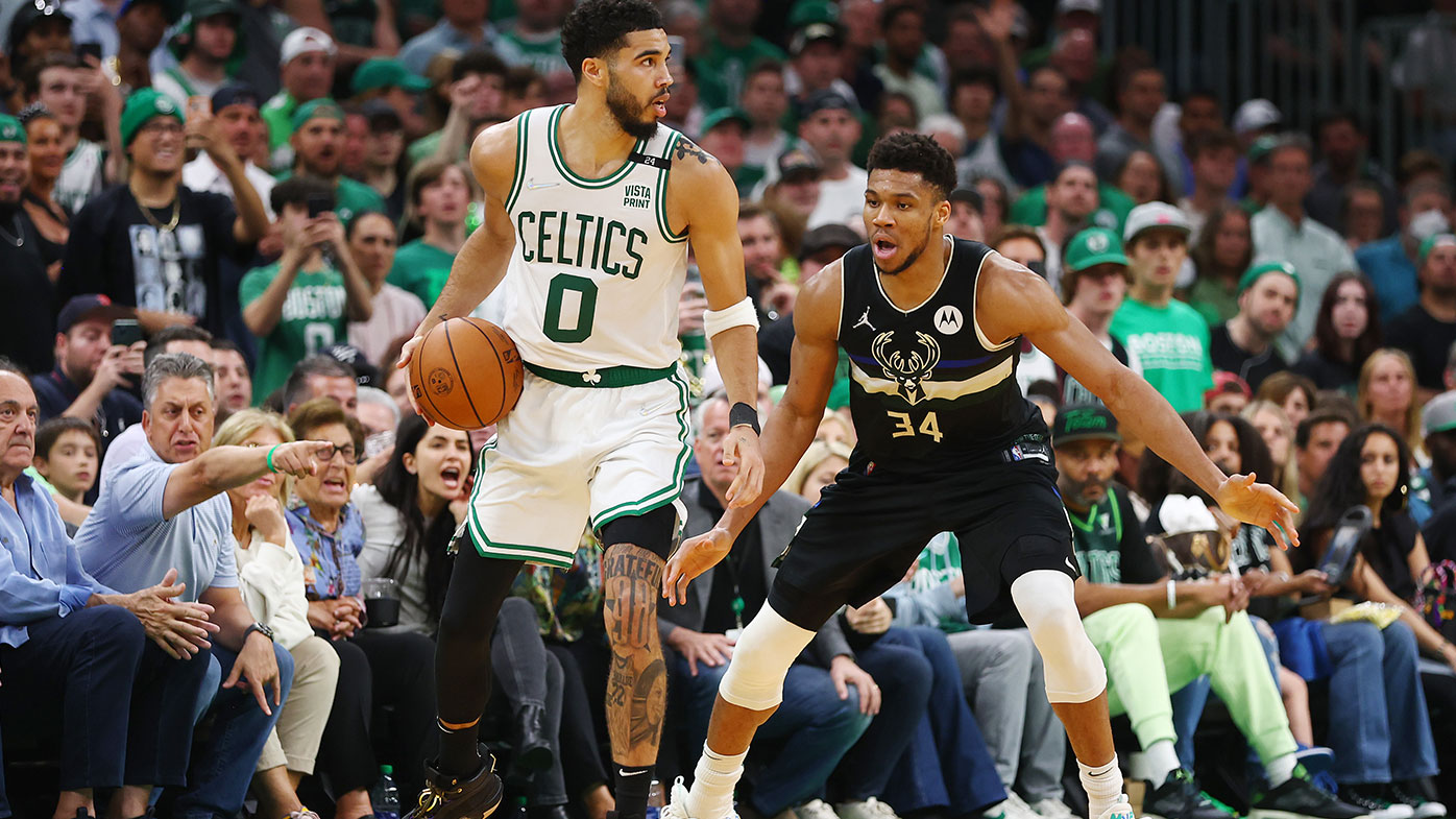 Jayson Tatum #0 of the Boston Celtics handles the ball against Giannis Antetokounmpo #34