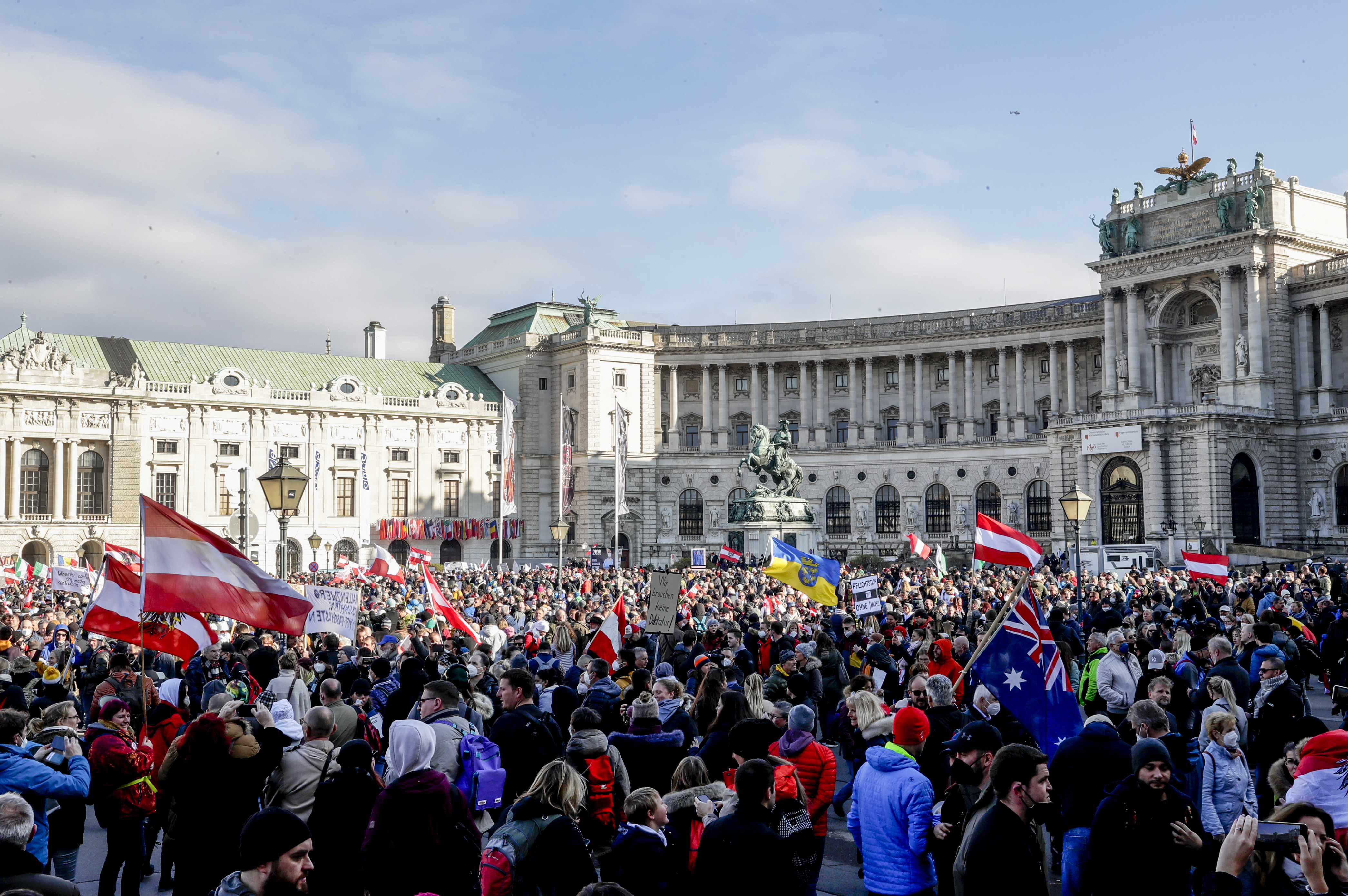 People take part in a demonstration against the country's coronavirus restrictions in Vienna, Austria