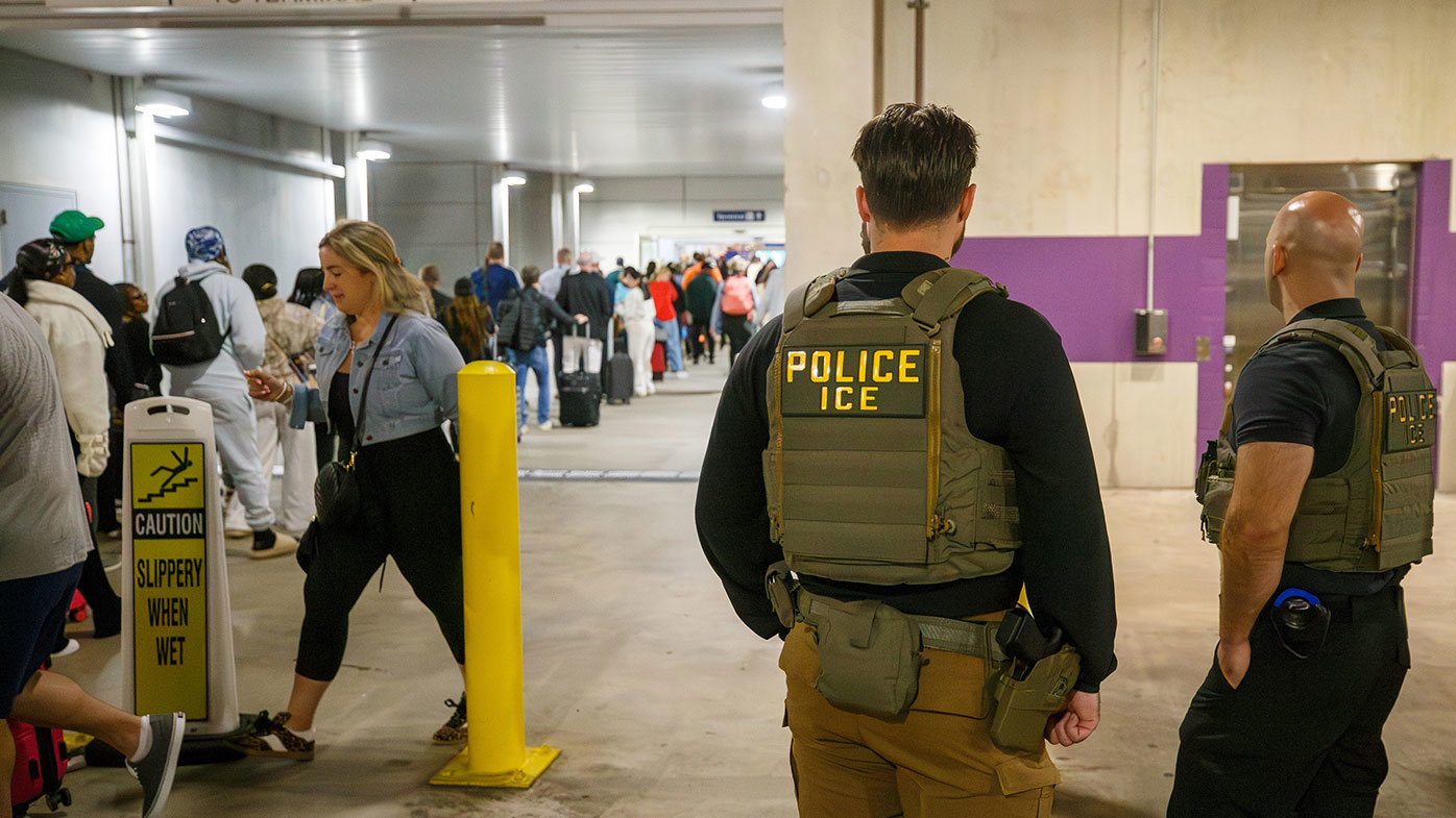 ICE agents outside Louis Armstrong International Airport.