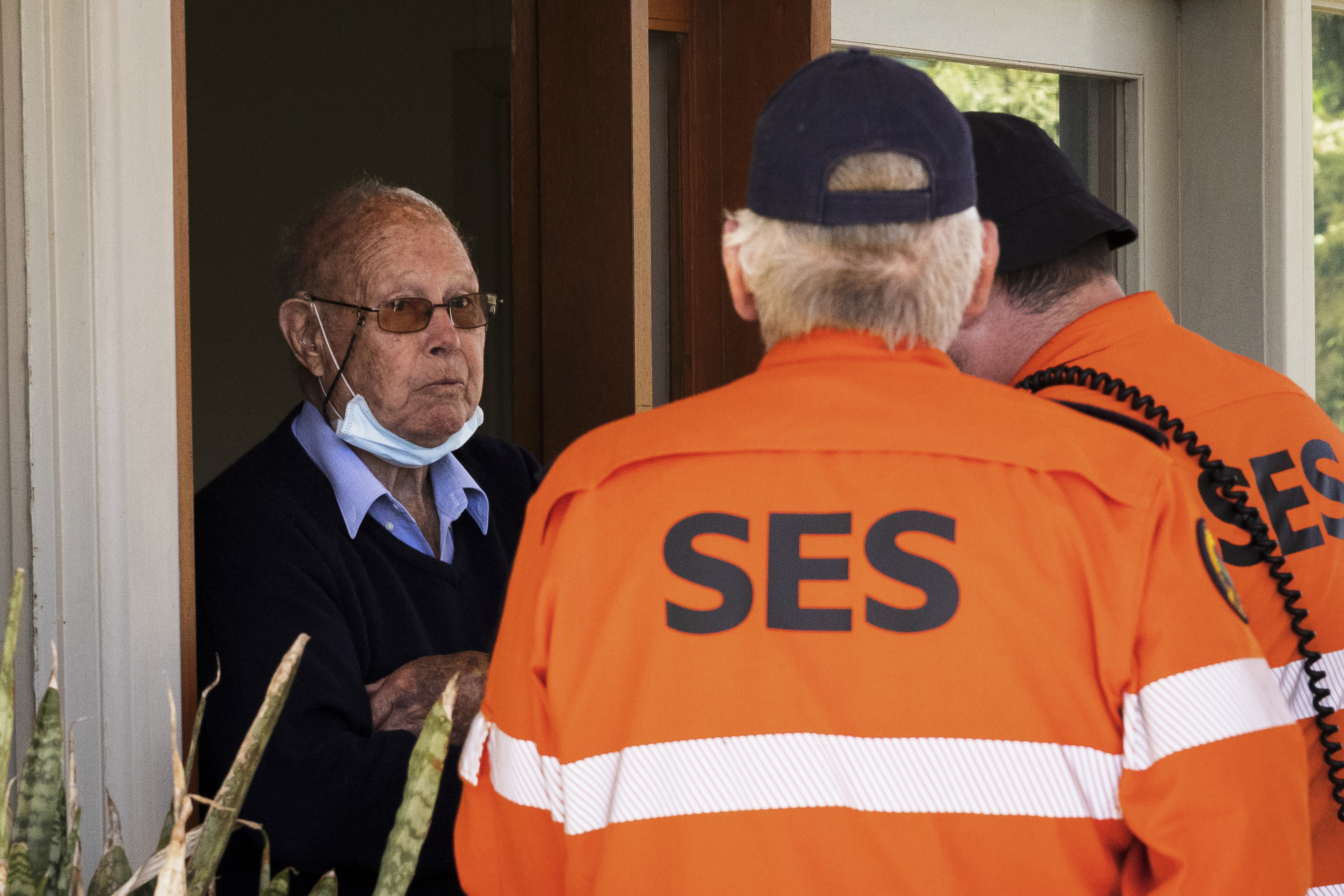 State Emergency Service (SES) workers go door to door as evacuation orders are made in advance of expected major flooding.