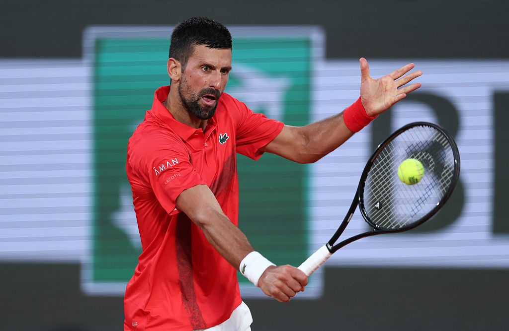 Novak Djokovic of Serbia plays a backhand against Filip Misolic of Austria.