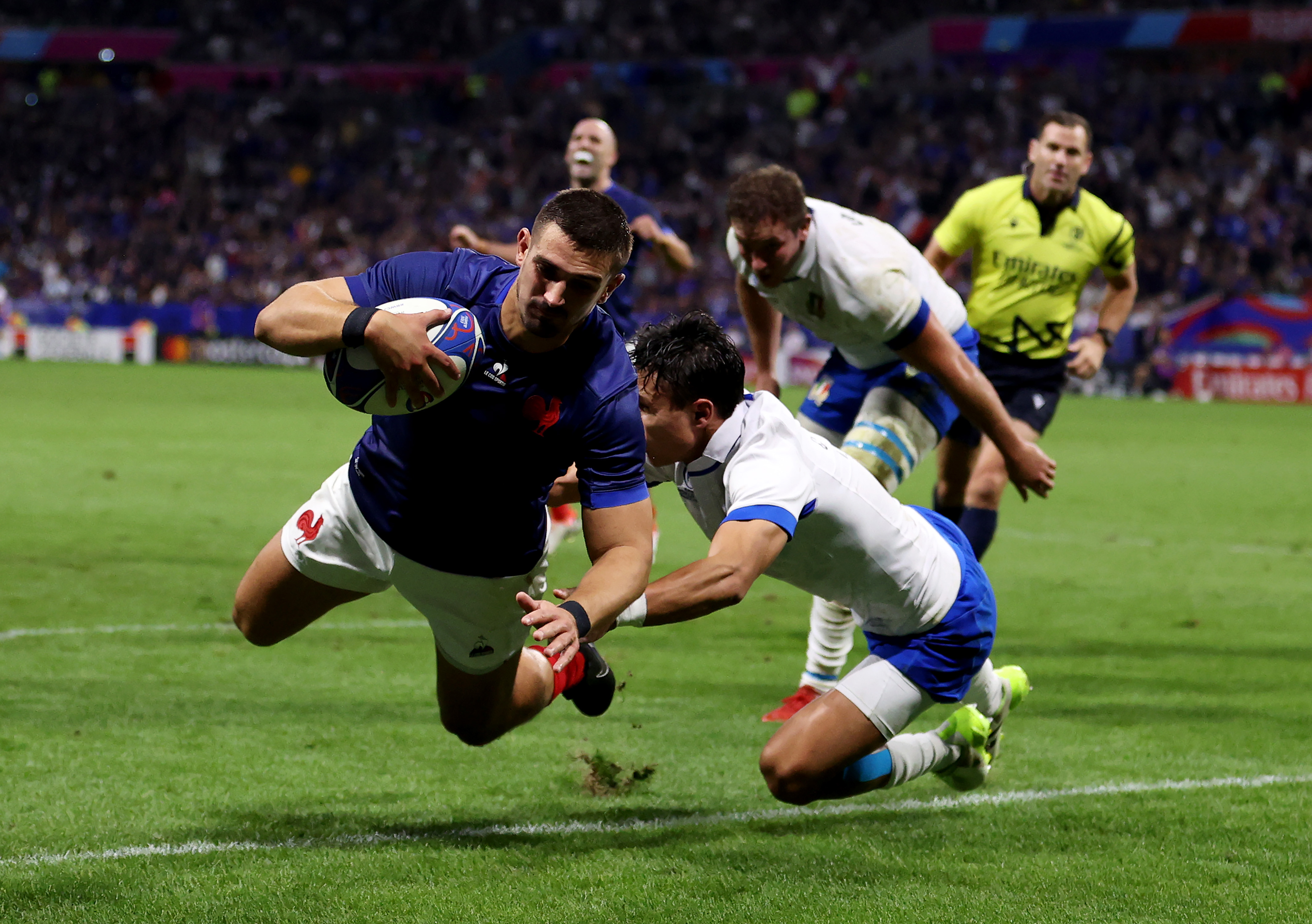 Thomas Ramos of France scores his team's third try.
