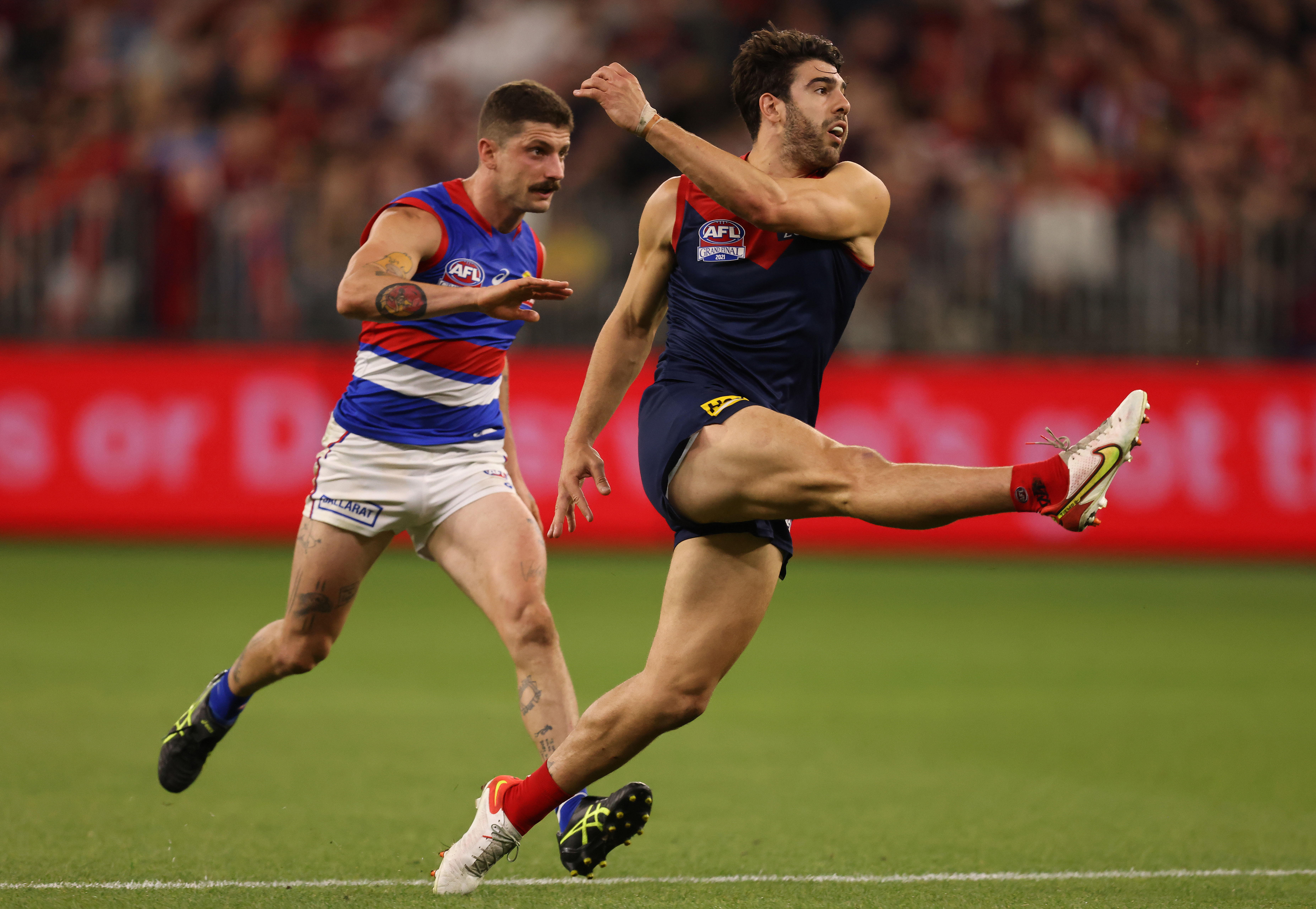 Christian Petracca of the Demons kicks the ball