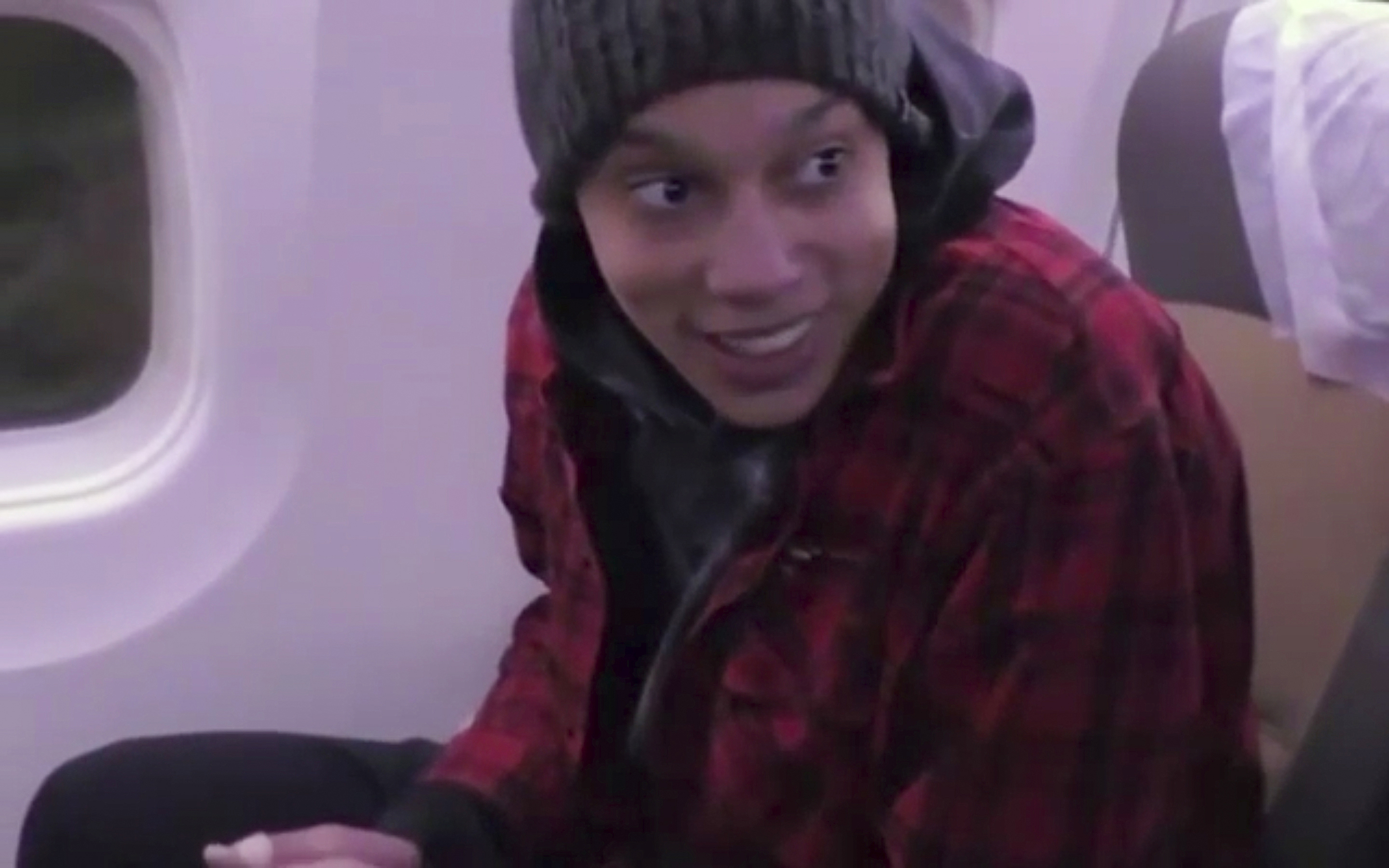 In this image made from video provided by Russian Federal Security Service, WNBA star and two-time Olympic gold medalist Brittney Griner sits in the plane as she flies to Abu Dhabi to be exchanged for Russian citizen Viktor Bout, in Russia, Friday, December 9, 2022.