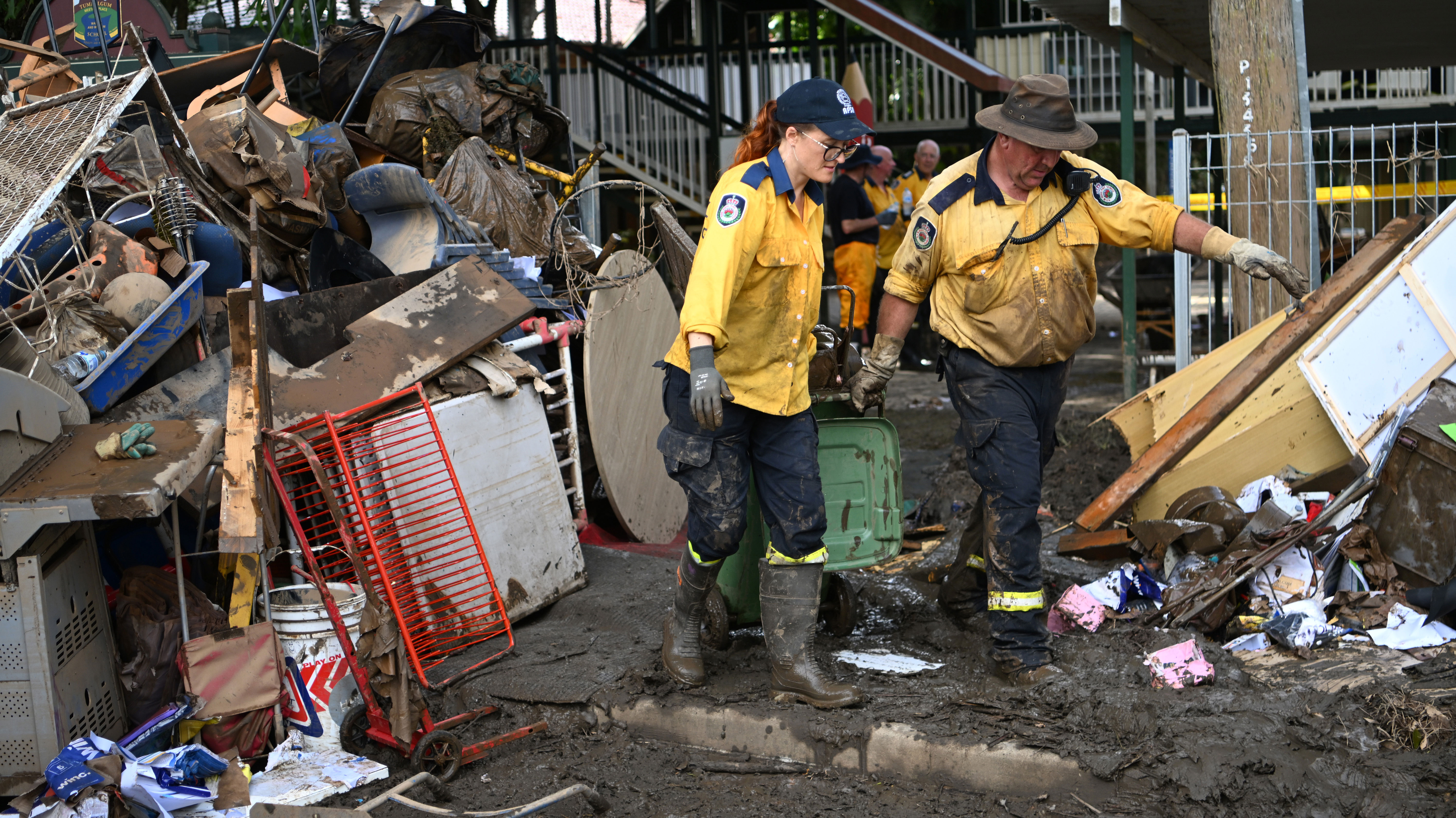 Volunteers from the local Rural Fire Brigade help to clean up a flood-affected primary school in Tumbulgum, Queensland.