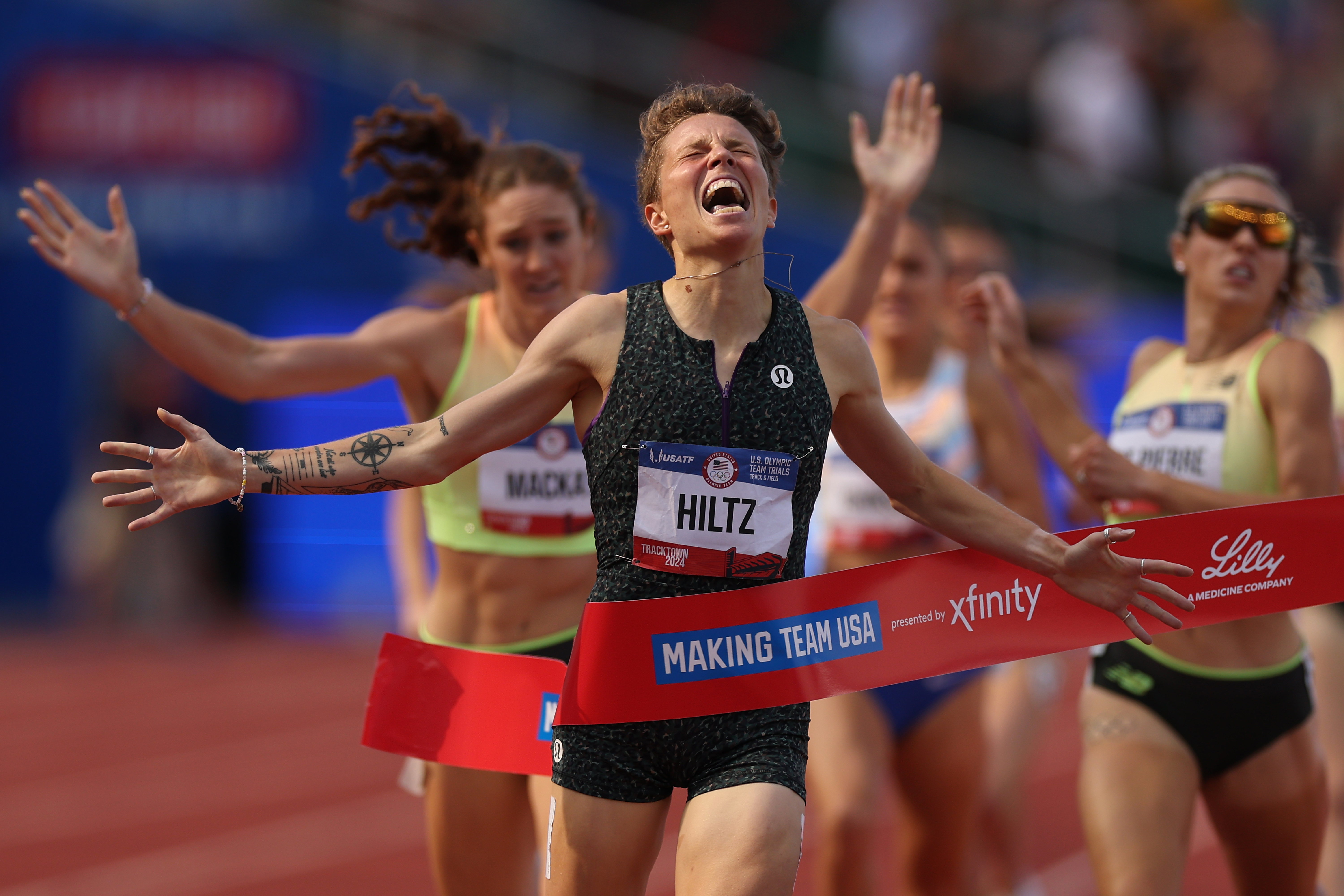 Nikki Hiltz celebrates crossing the finish line to win the women's 1500 metre final at the Olympic trials.