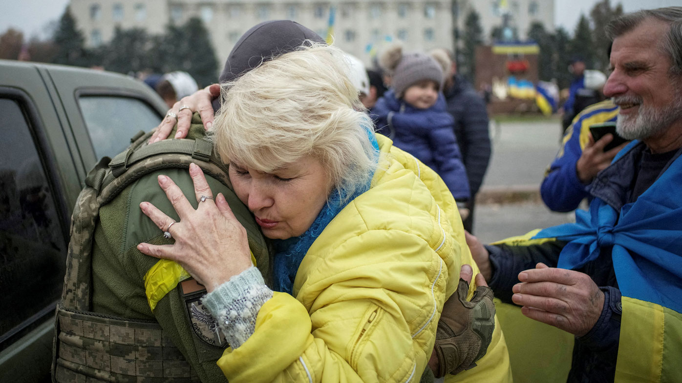 A local hugs a Ukrainian serviceman as people celebrate after Russia's retreat from Kherson city
