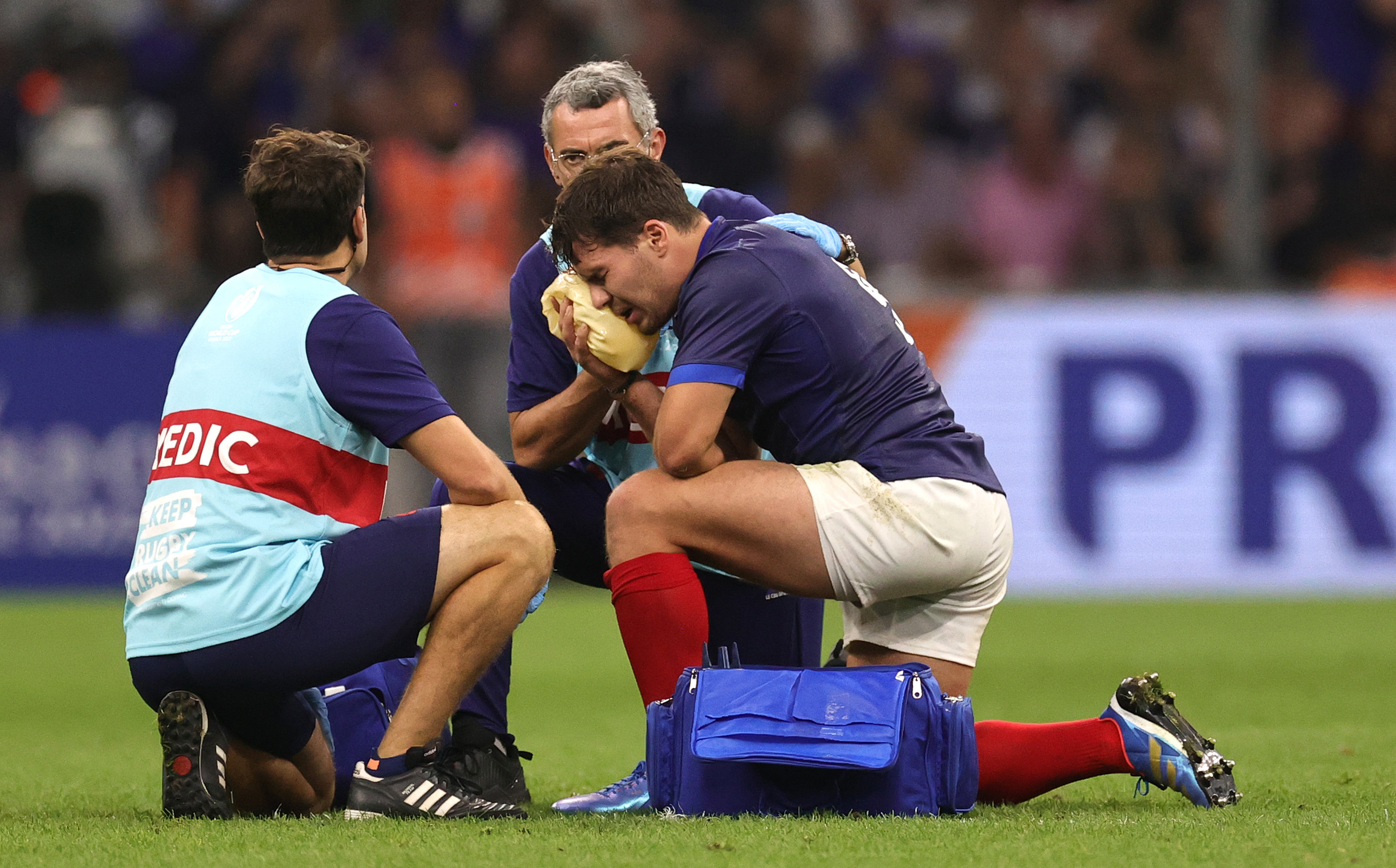 Antoine Dupont, the France captain, receives treatment following head contact with Johan Deysel.