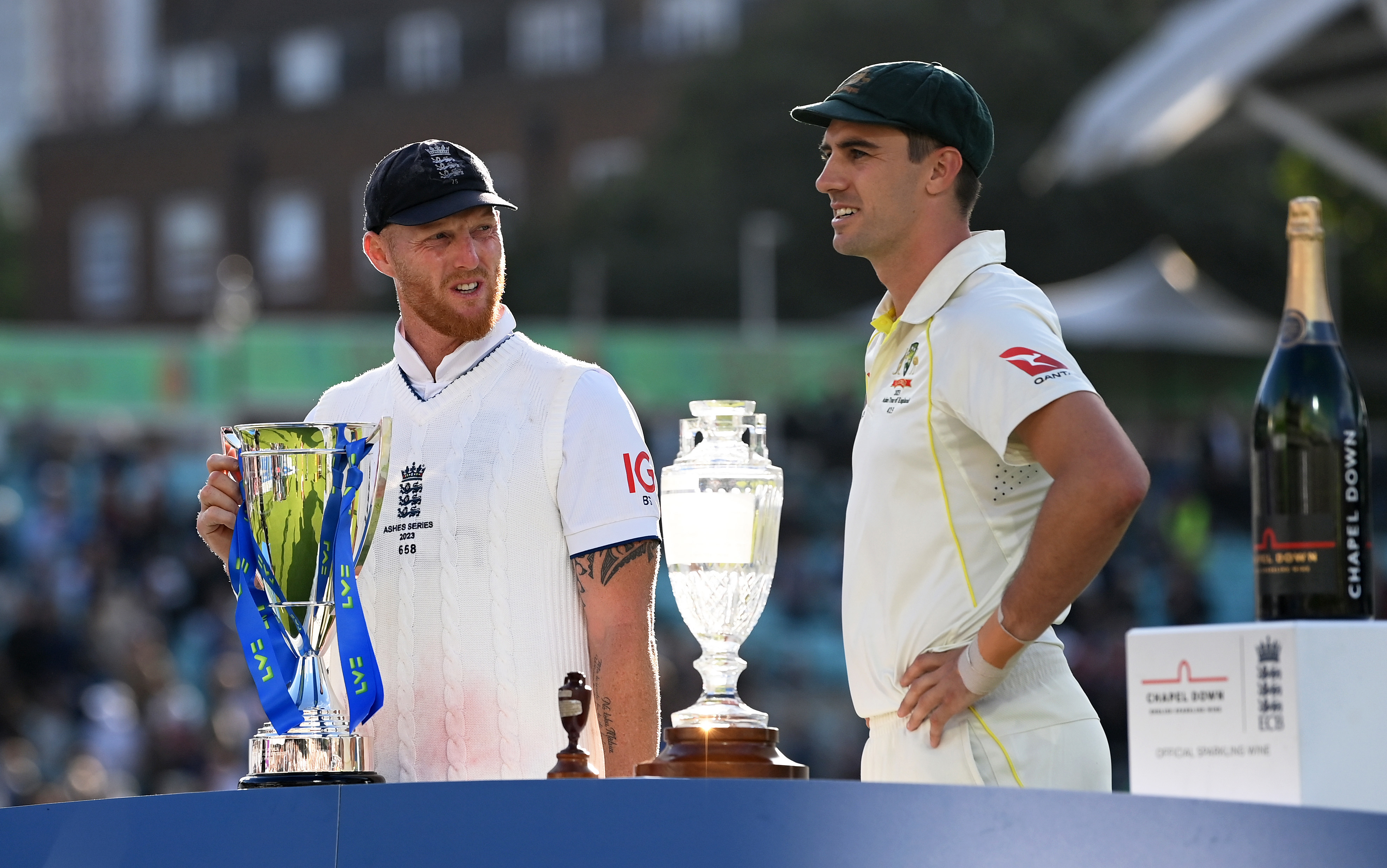 Pat Cummins of Australia and Ben Stokes of England pose with the Ashes trophy.