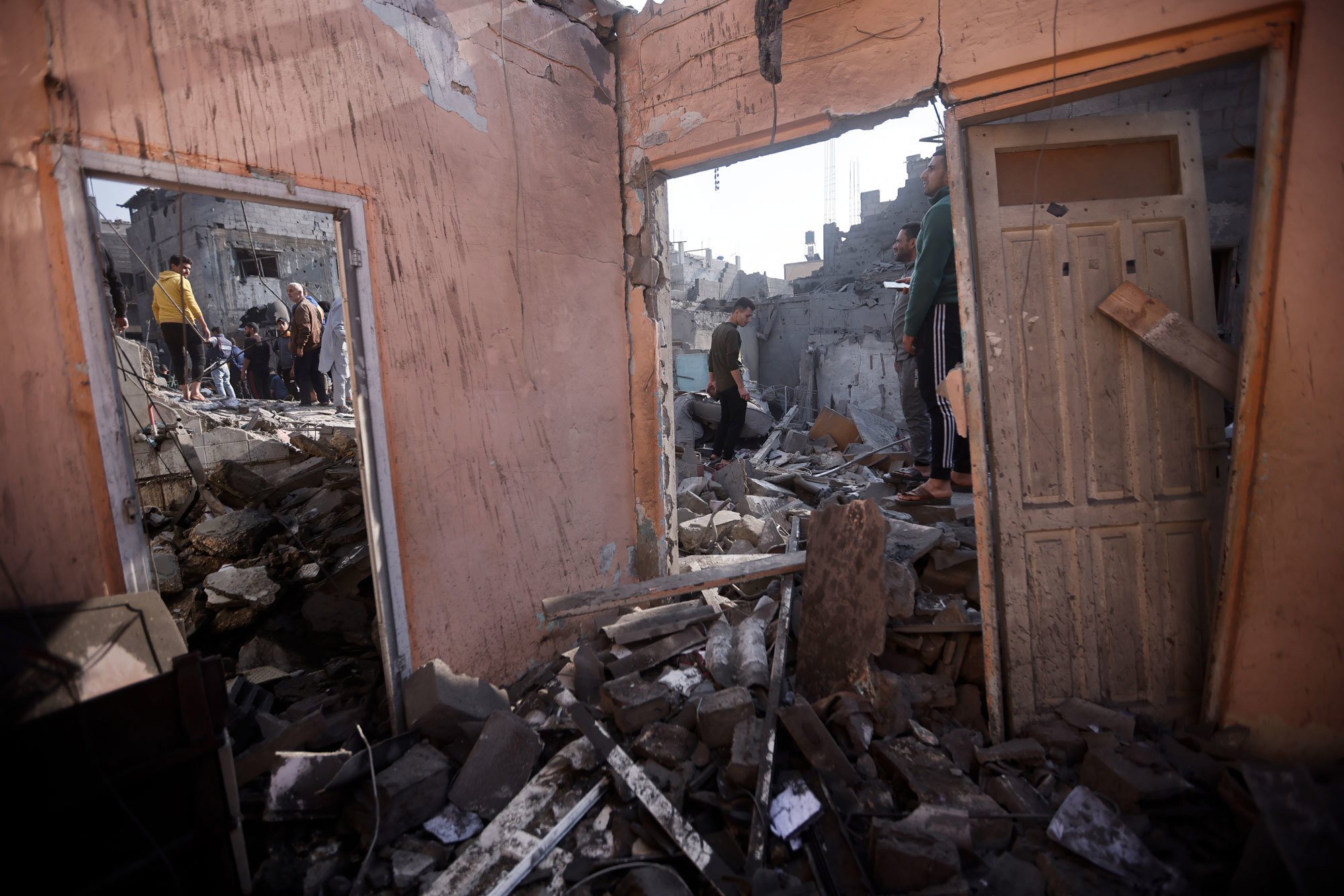 Palestinians look at destruction after the Israeli bombing In Khan Younis refugee camp in Gaza Strip on Friday, Dec. 1, 2023.