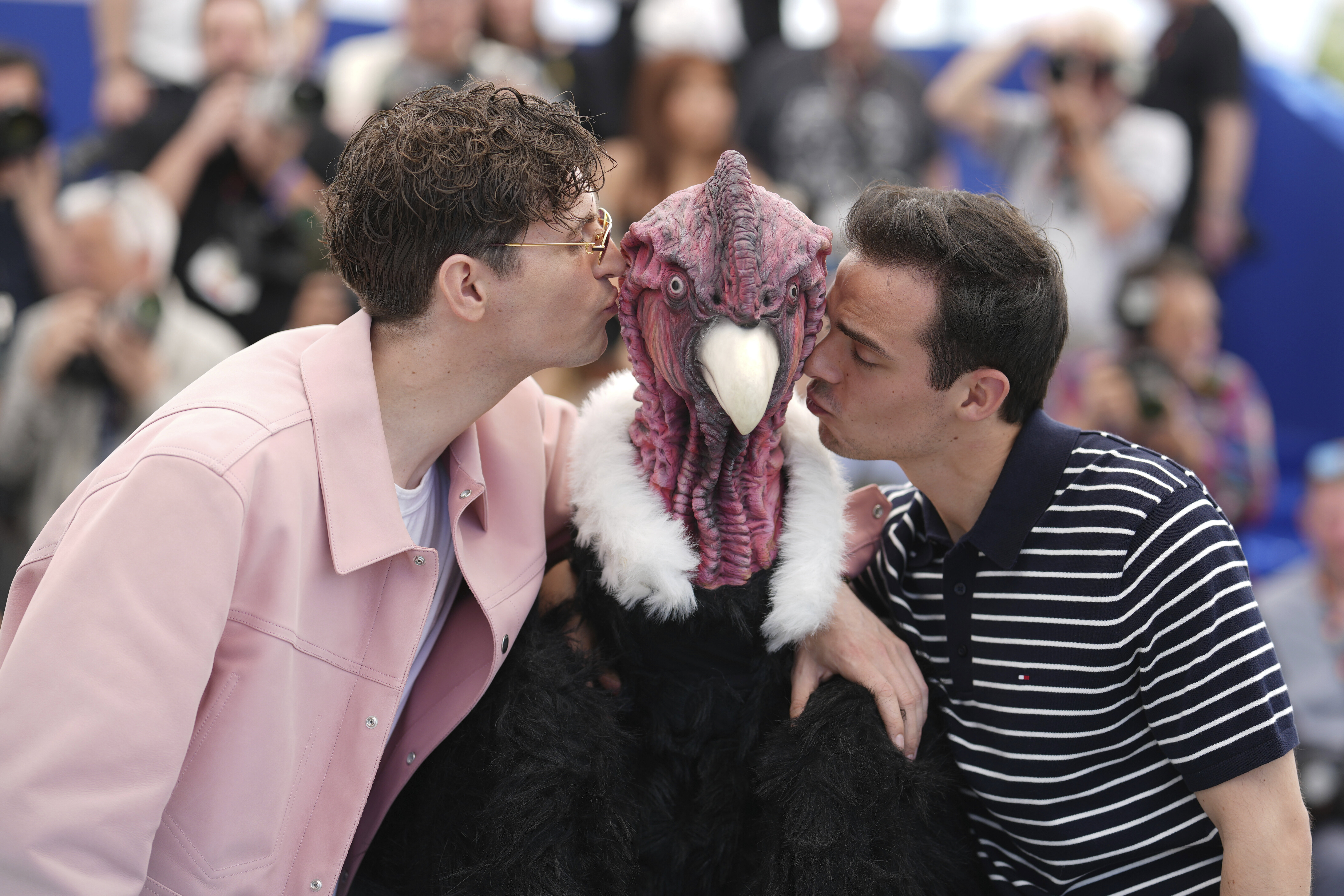 Raphael Quenard and Hugo David pose with a person dressed in bird costume at a photocall for the film Die, My Love at the 78th international film festival, Cannes, May 18, 2025.
