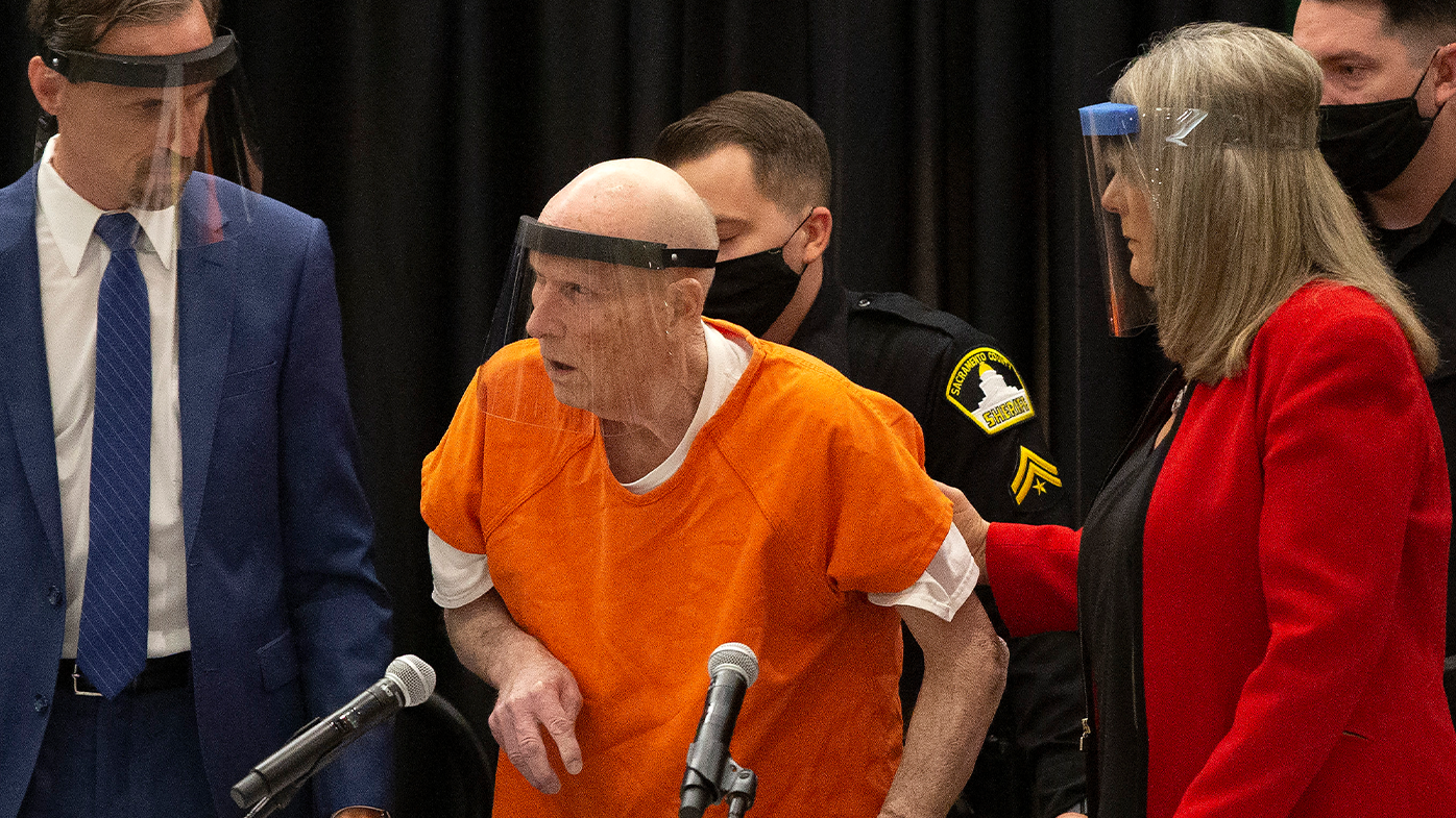In this June 29, 2020, file photo, Joseph James DeAngelo, center, charged with being the Golden State Killer, is helped up by his attorney, Diane Howard, as Sacramento Superior Court Judge Michael Bowman enters the courtroom in Sacramento, Calif.  (AP Photo/Rich Pedroncelli, File)