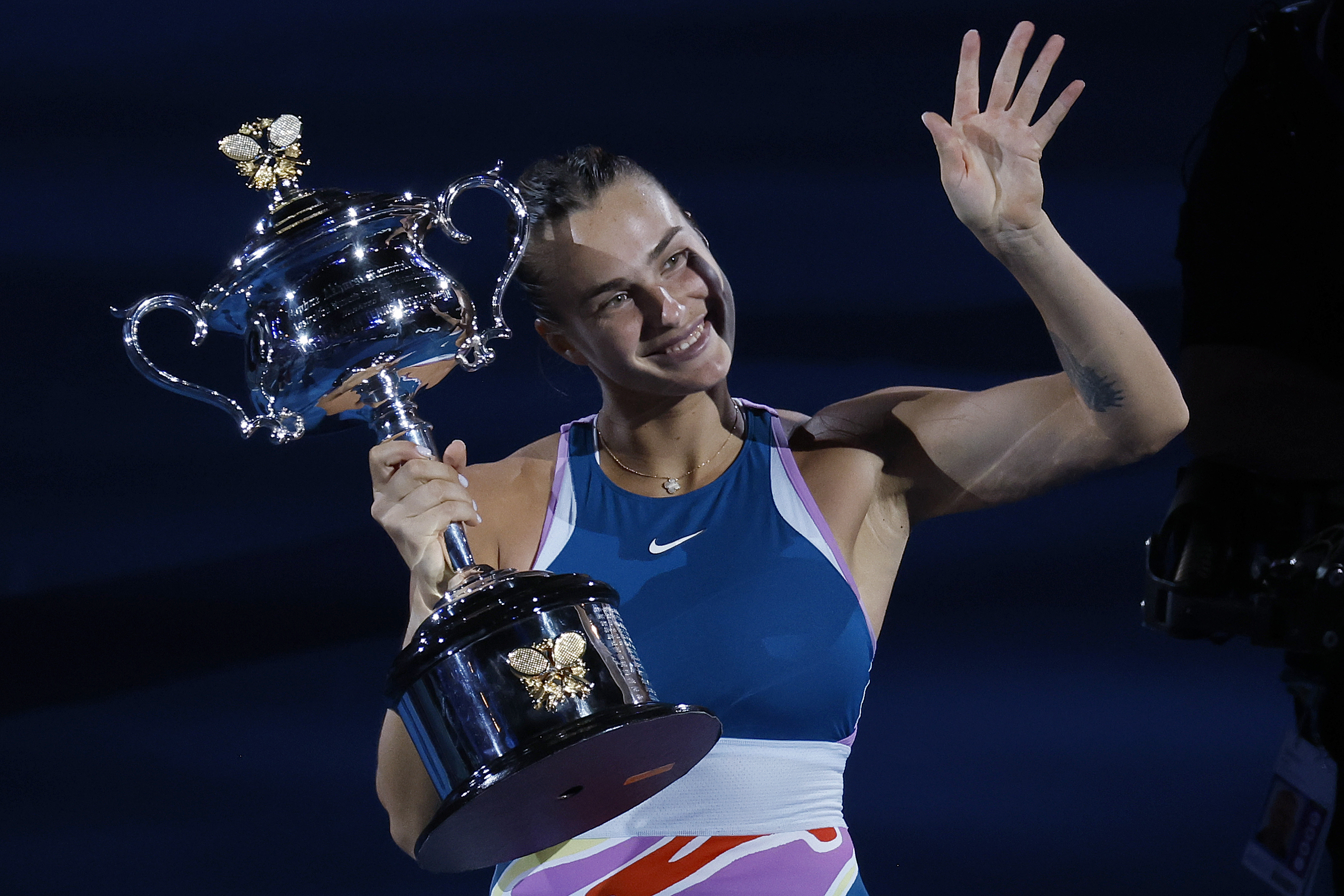 Aryna Sabalenka of Belarus waves as she holds the Daphne Akhurst Memorial Trophy.