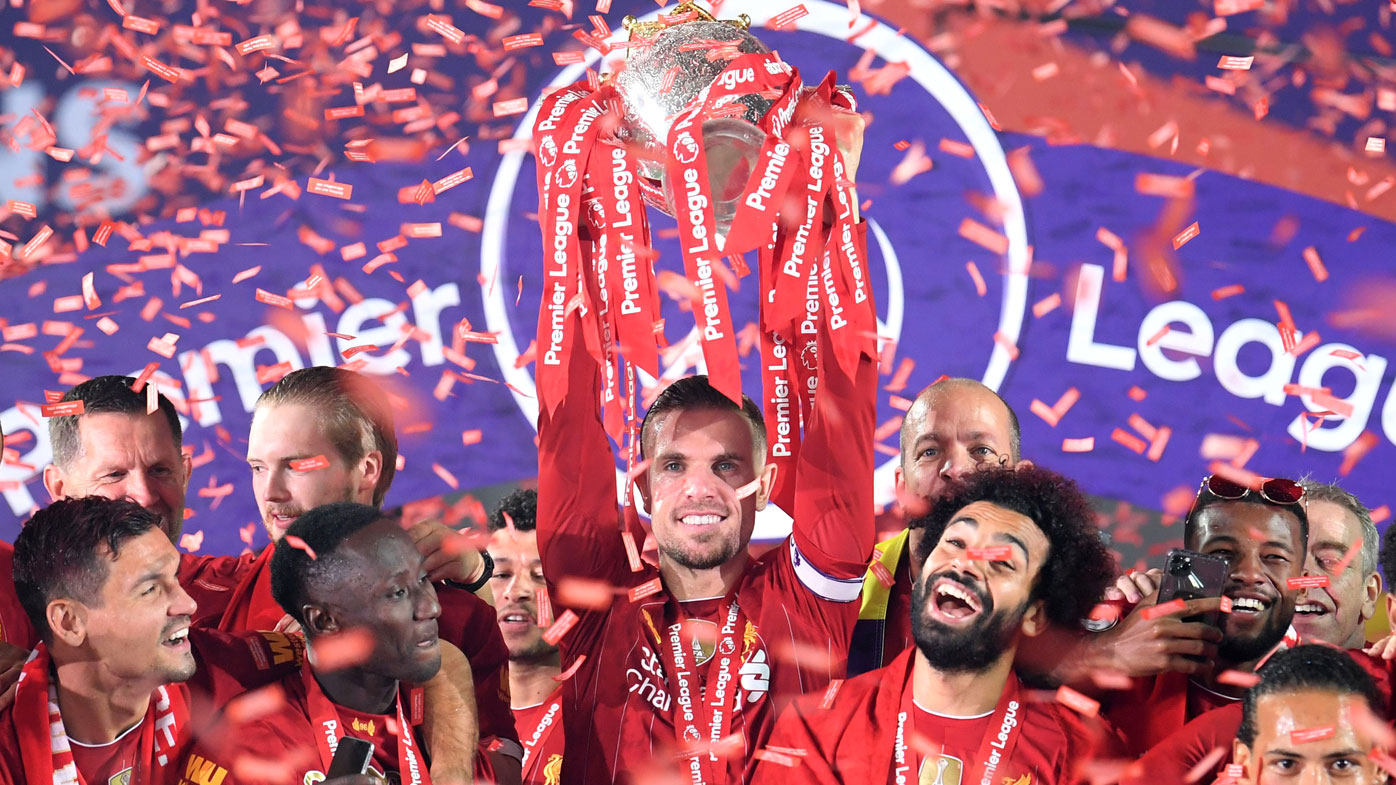  Jordan Henderson of Liverpool lifts The Premier League trophy