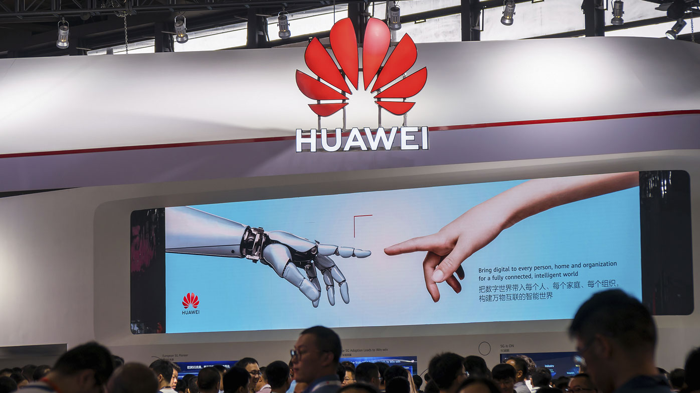 In this June 26, 2019, photo, visitors tour the Huawei pavilion at the Mobile World Congress in Shanghai, China.
