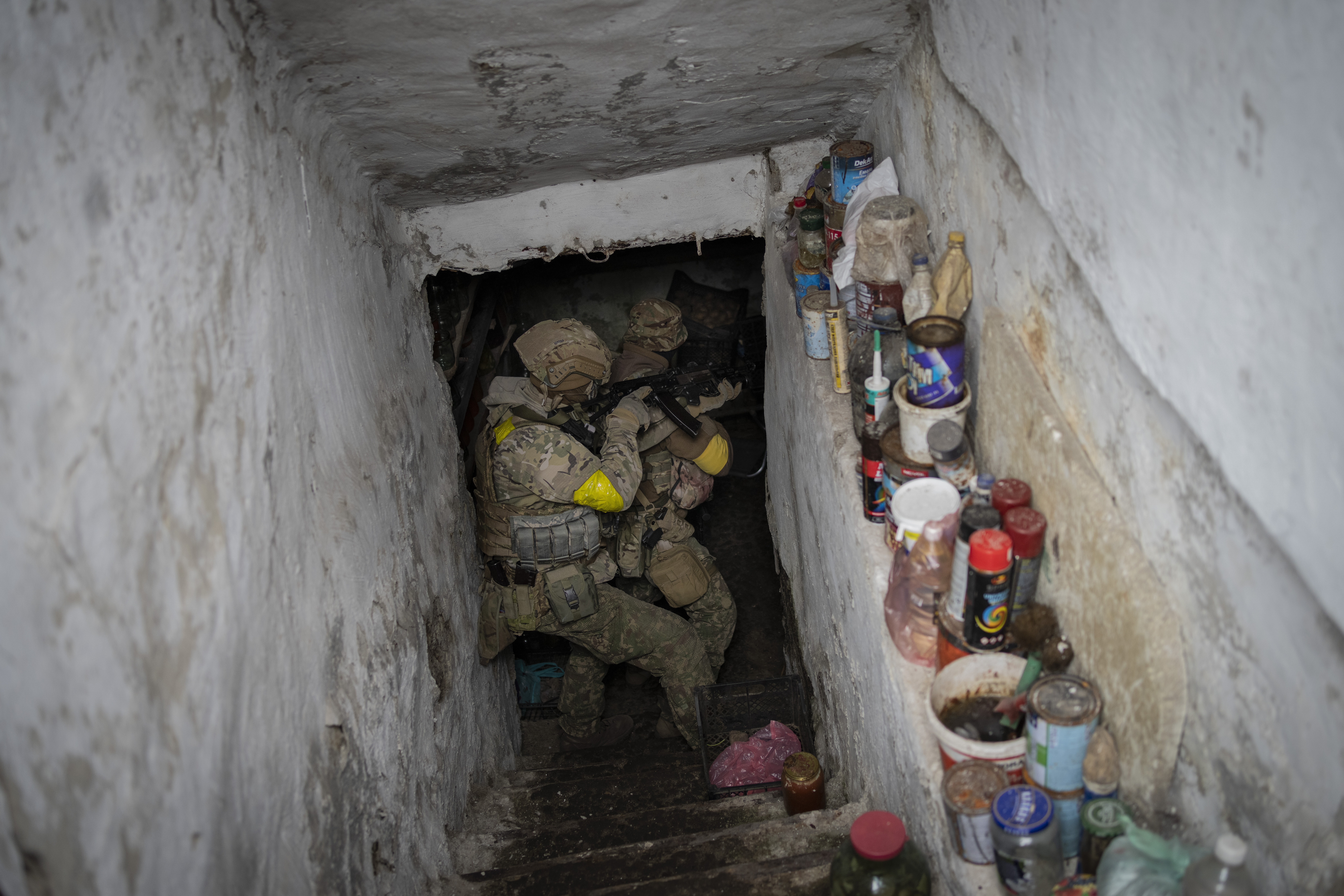 Ukrainian National Guard soldiers inspect a basement during a reconnaissance mission in a recently retaken village on the outskirts of Kharkiv, east Ukraine, Saturday, May 14, 2022. 