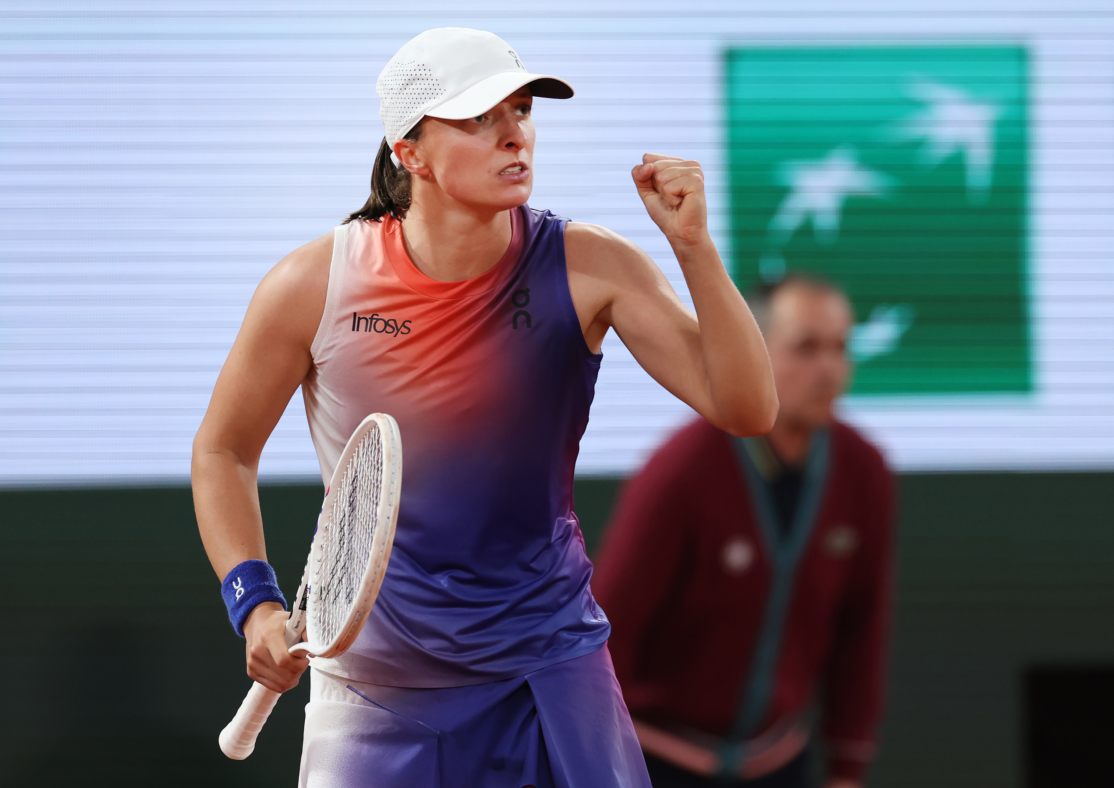 Iga Swiatek of Poland celebrates a point over Naomi Osaka of Japan.