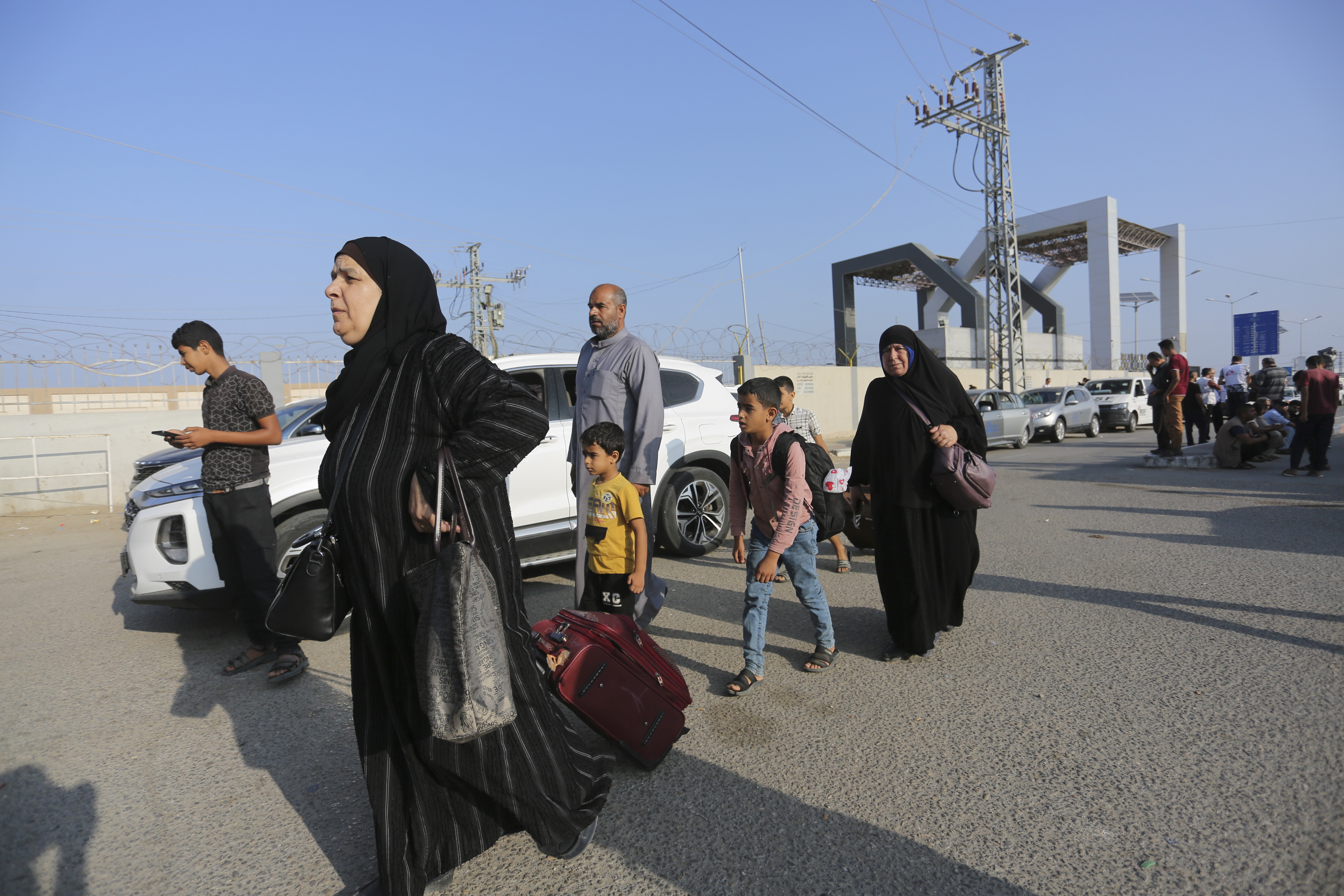 Palestinians wait at the Rafah border crossing