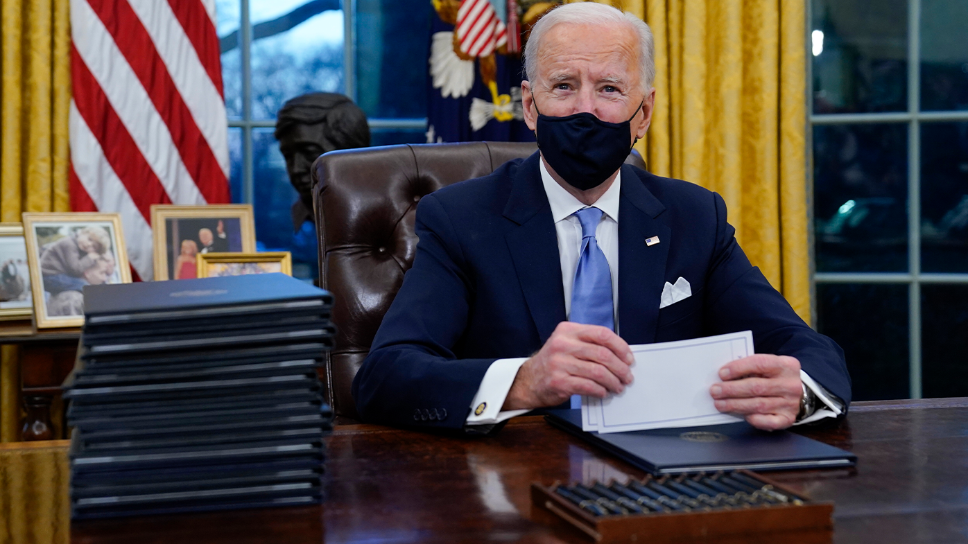 President Joe Biden pauses as he signs his first executive orders in the Oval Office of the White House on Wednesday, Jan. 20, 2021, in Washington. (AP Photo/Evan Vucci)