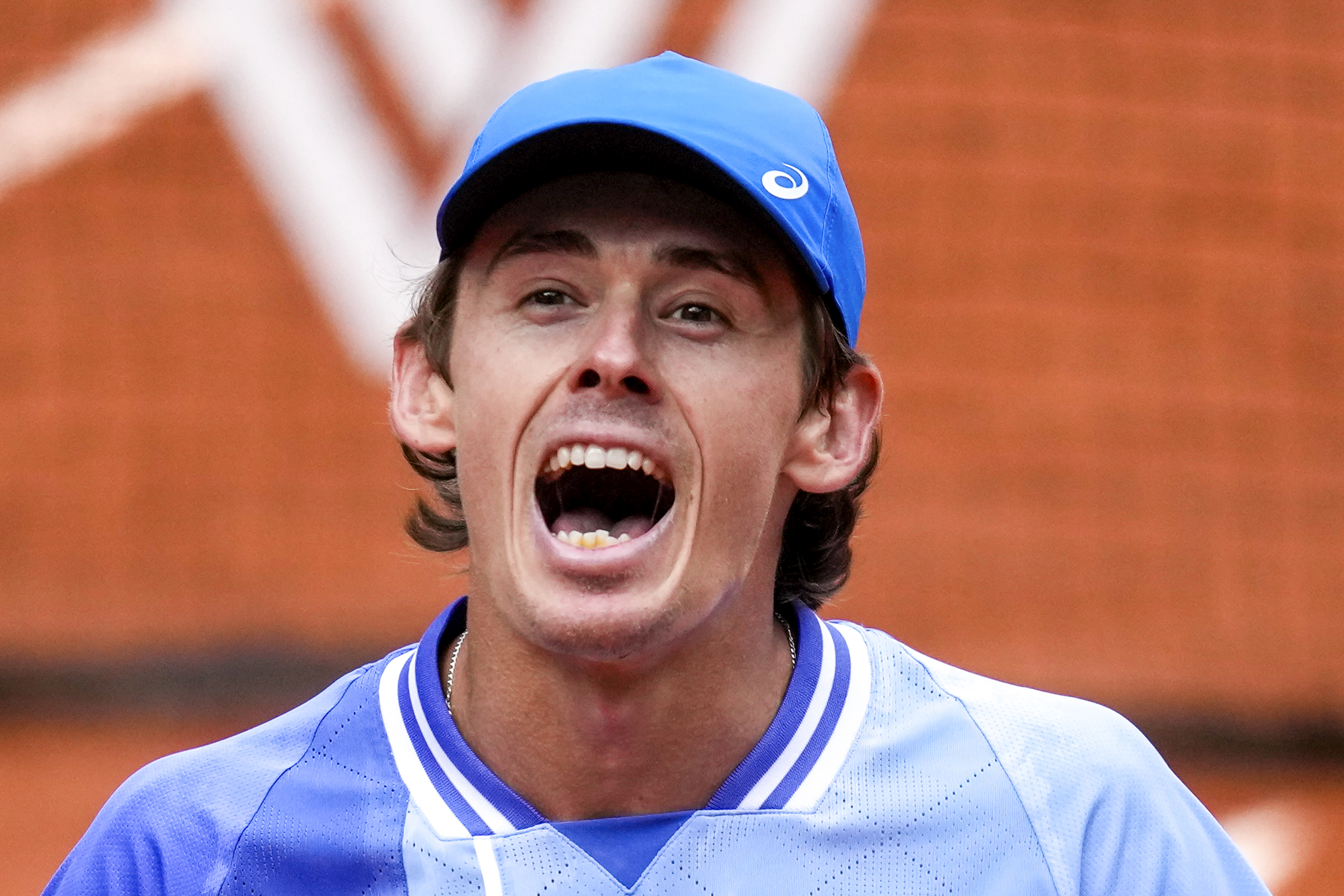 Australia's Alex De Minaur celebrates winning his fourth round match of the French Open tennis tournament against Russia's Daniil Medvedev.