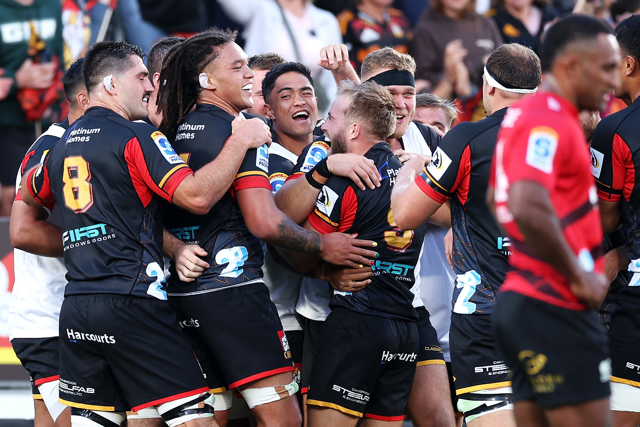 Xavier Roe of the Chiefs celebrates with his team mates after scoring a try during the round one.