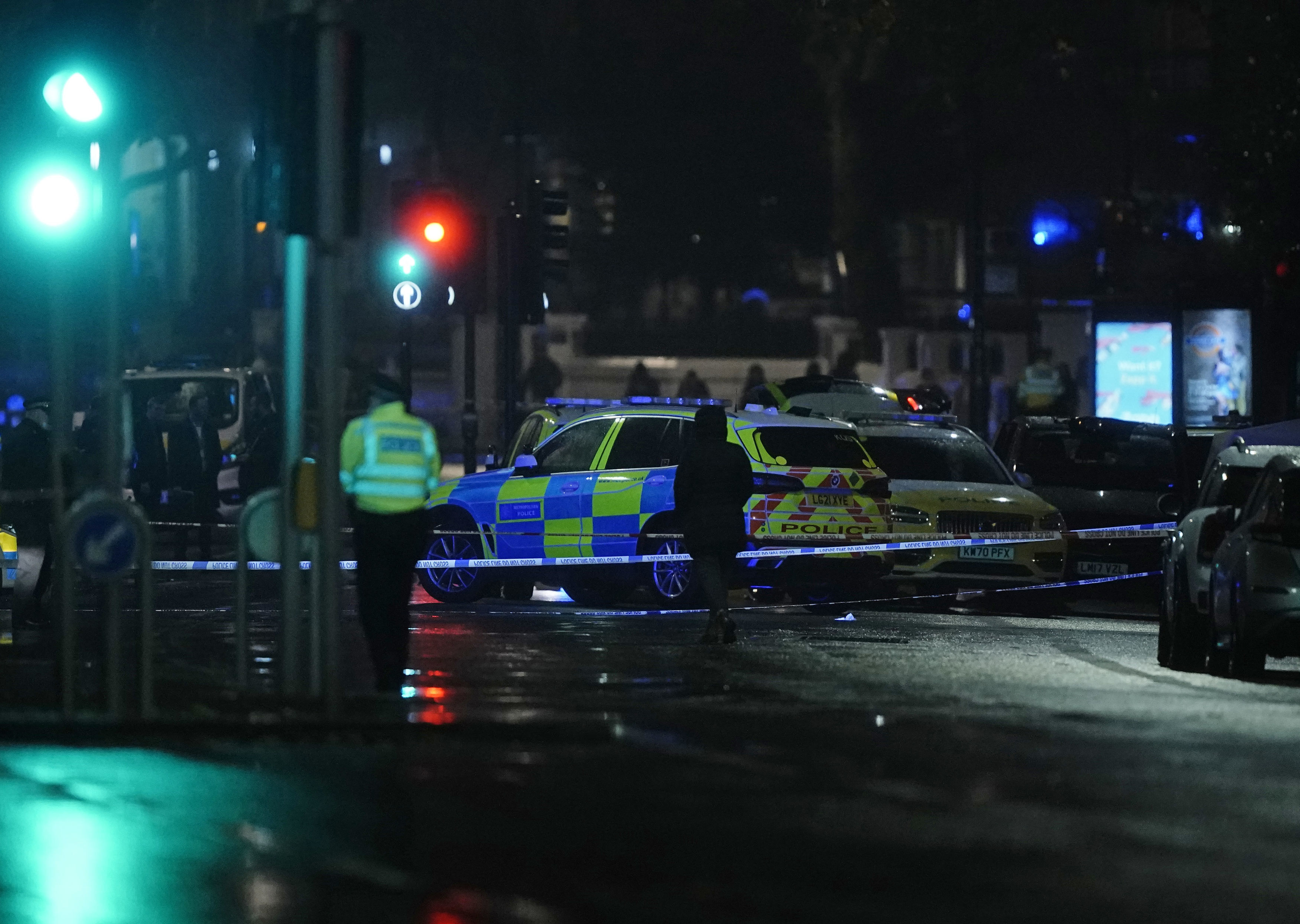 Police attend the scene near Kensington High Street, where British police say a man has been shot dead during a confrontation with officers. (Aaron Chown/PA via AP)
