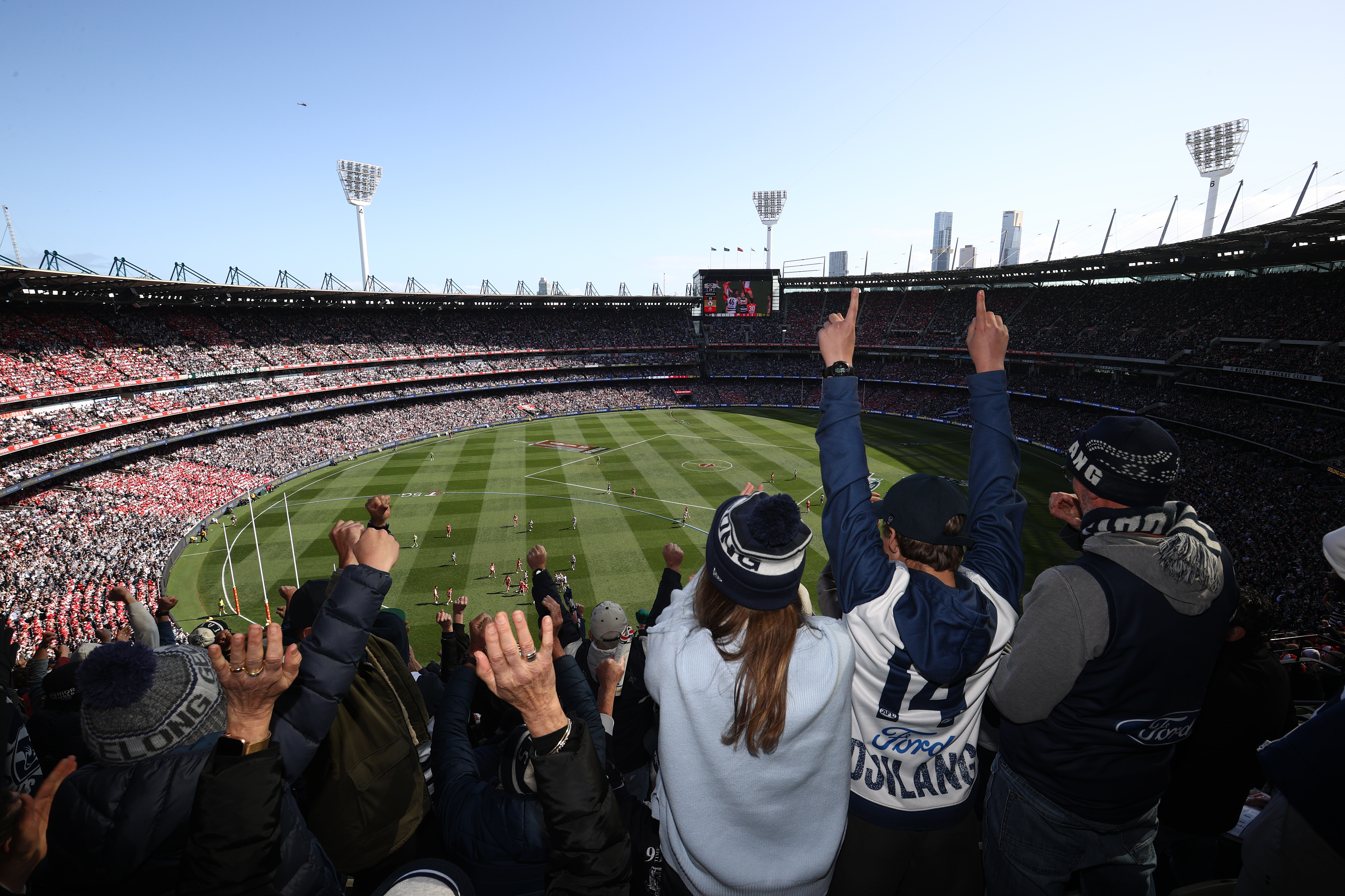 Cats fans celebrate a goal during the 2022 AFL Grand Final match between the Geelong Cats and the Sydney Swans at the Melbourne Cricket Ground on September 24, 2022 in Melbourne, Australia. (Photo by Robert Cianflone/AFL Photos/via Getty Images)