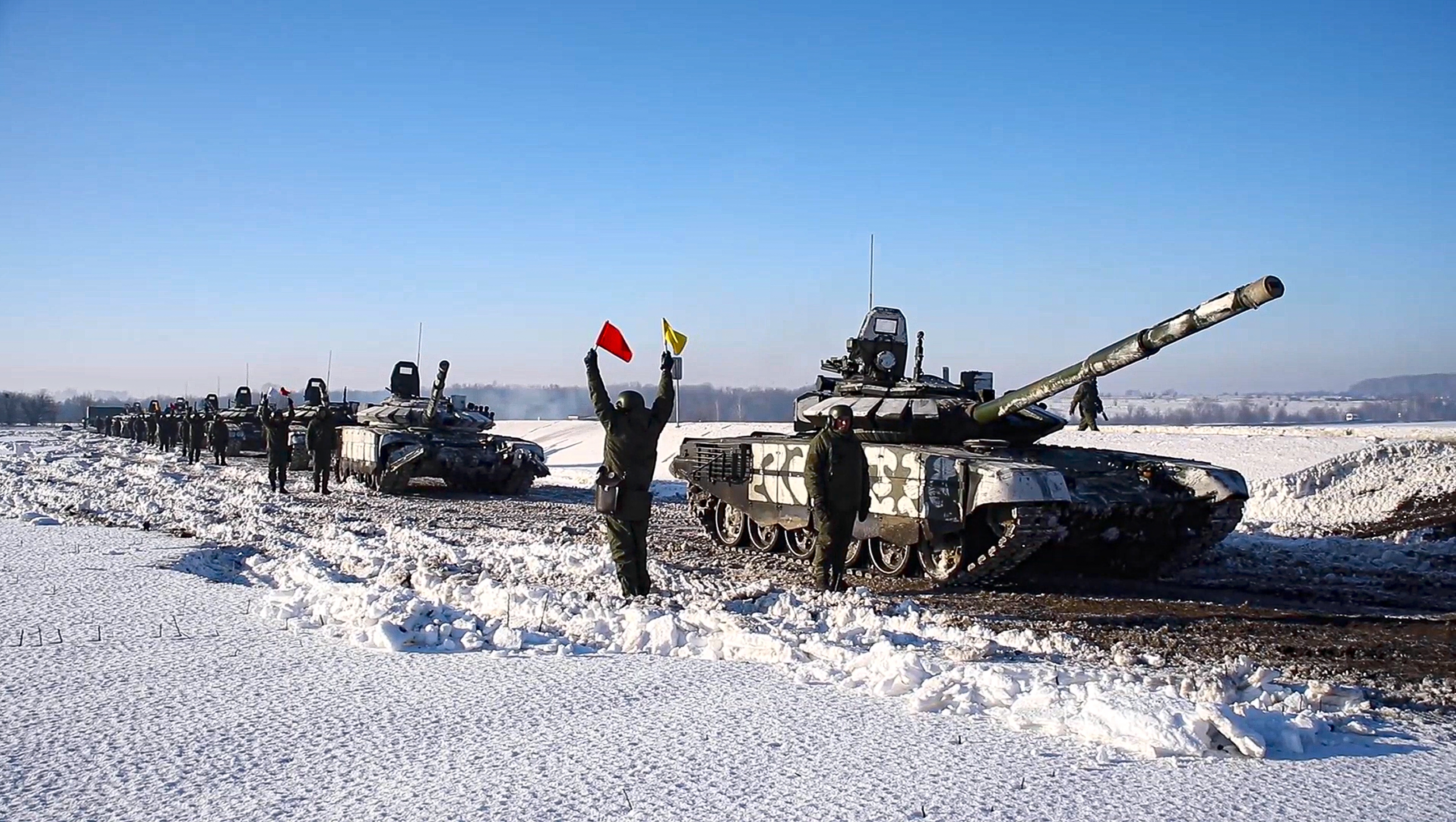 In this photo taken from video provided by the Russian Defense Ministry Press Service on Tuesday, Feb. 15, 2022, Russian army tanks stand ready to move back to their permanent base after drills in Russia.  