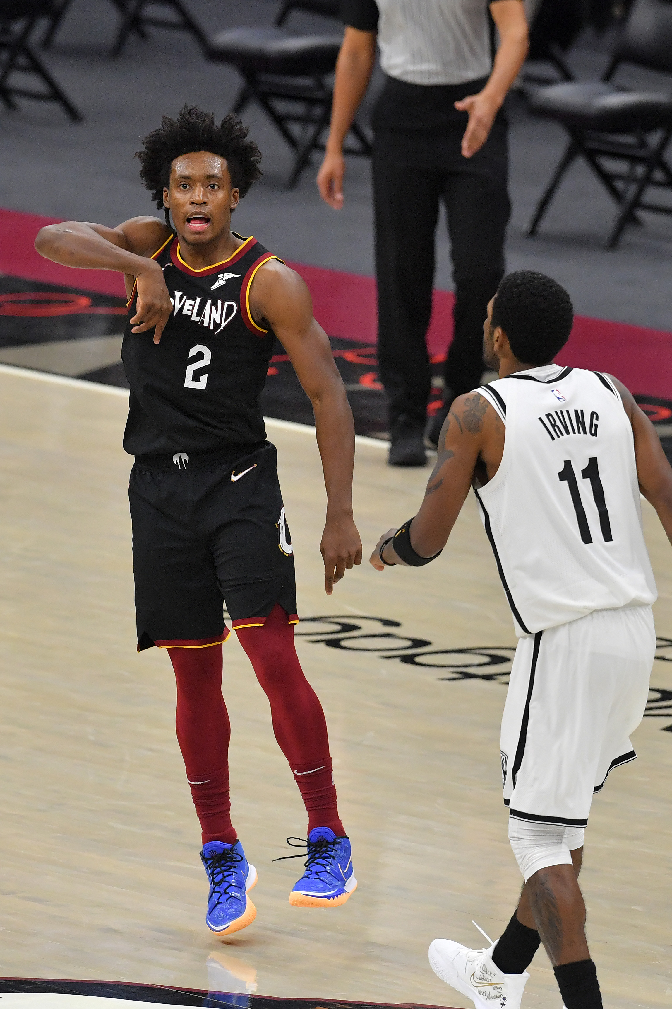 Kyrie Irving of the Brooklyn Nets watches as Collin Sexton of the Cleveland Cavaliers celebrates.