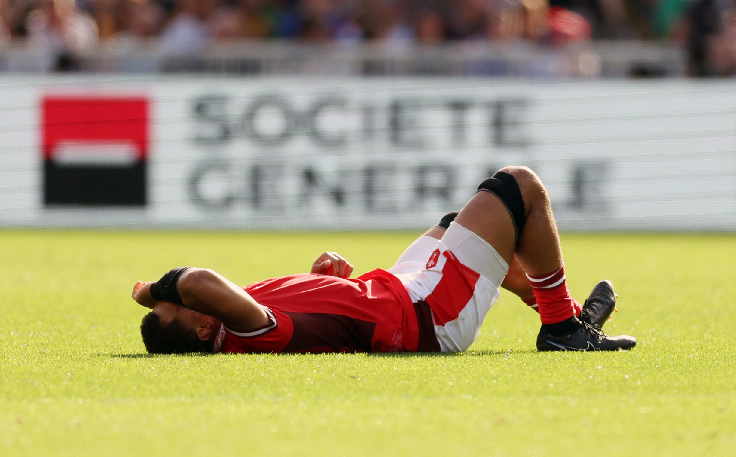 Taulupe Faletau of Wales lays injured at Stade de la Beaujoire.