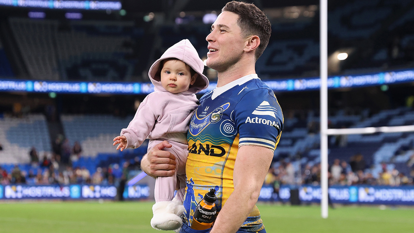 Mitchell Moses of the Eels walks on the field with his daughter after winning the round 12 NRL match between South Sydney Rabbitohs and Parramatta Eels at Allianz Stadium on May 19, 2023 in Sydney, Australia. (Photo by Cameron Spencer/Getty Images)