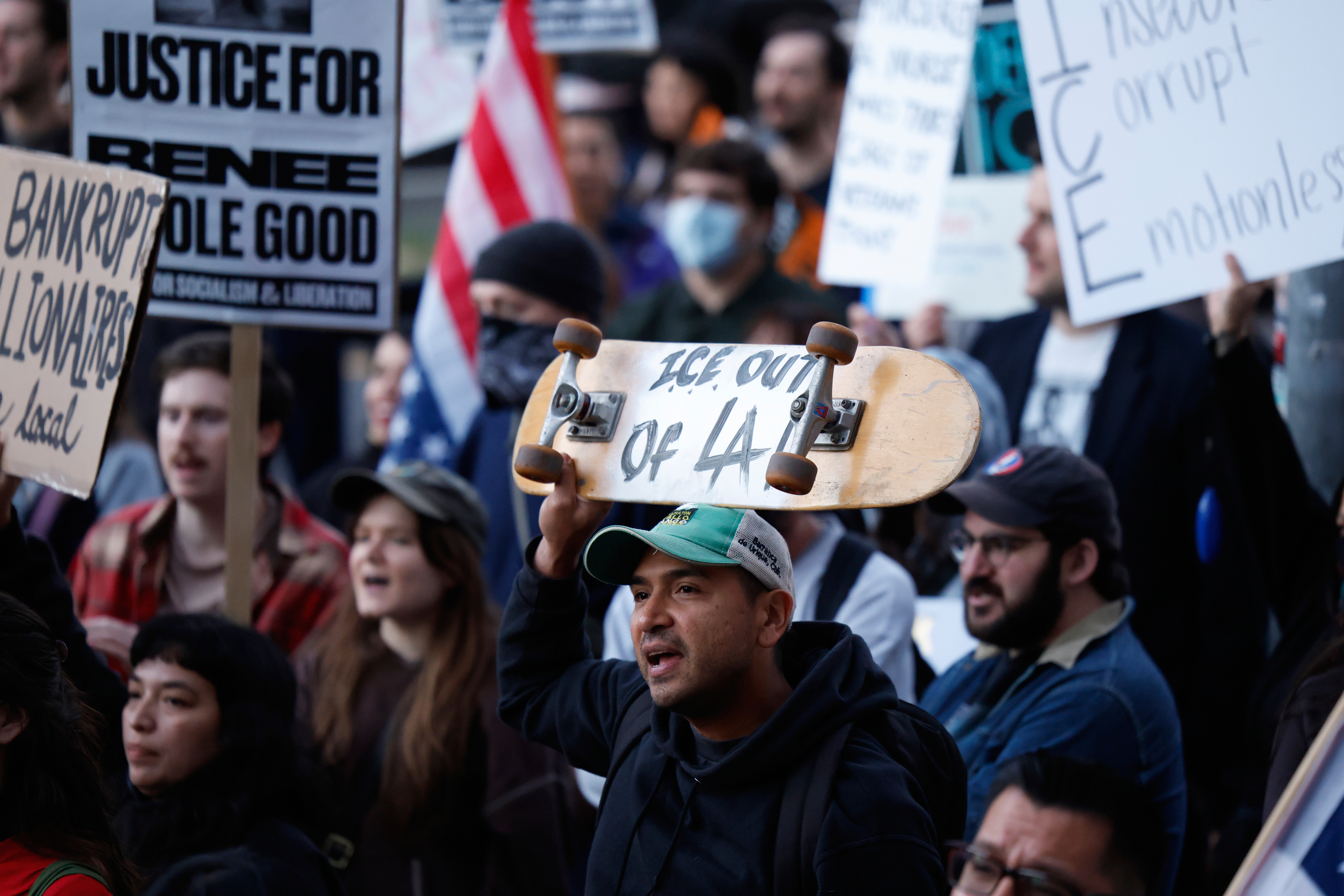 Demonstrators hold signs during a protest in response to the fatal shooting of 37-year-old Alex Pretti in Minneapolis earlier in the day Saturday, Jan. 24, 2026, in Los Angeles. (AP Photo/Caroline Brehman)
