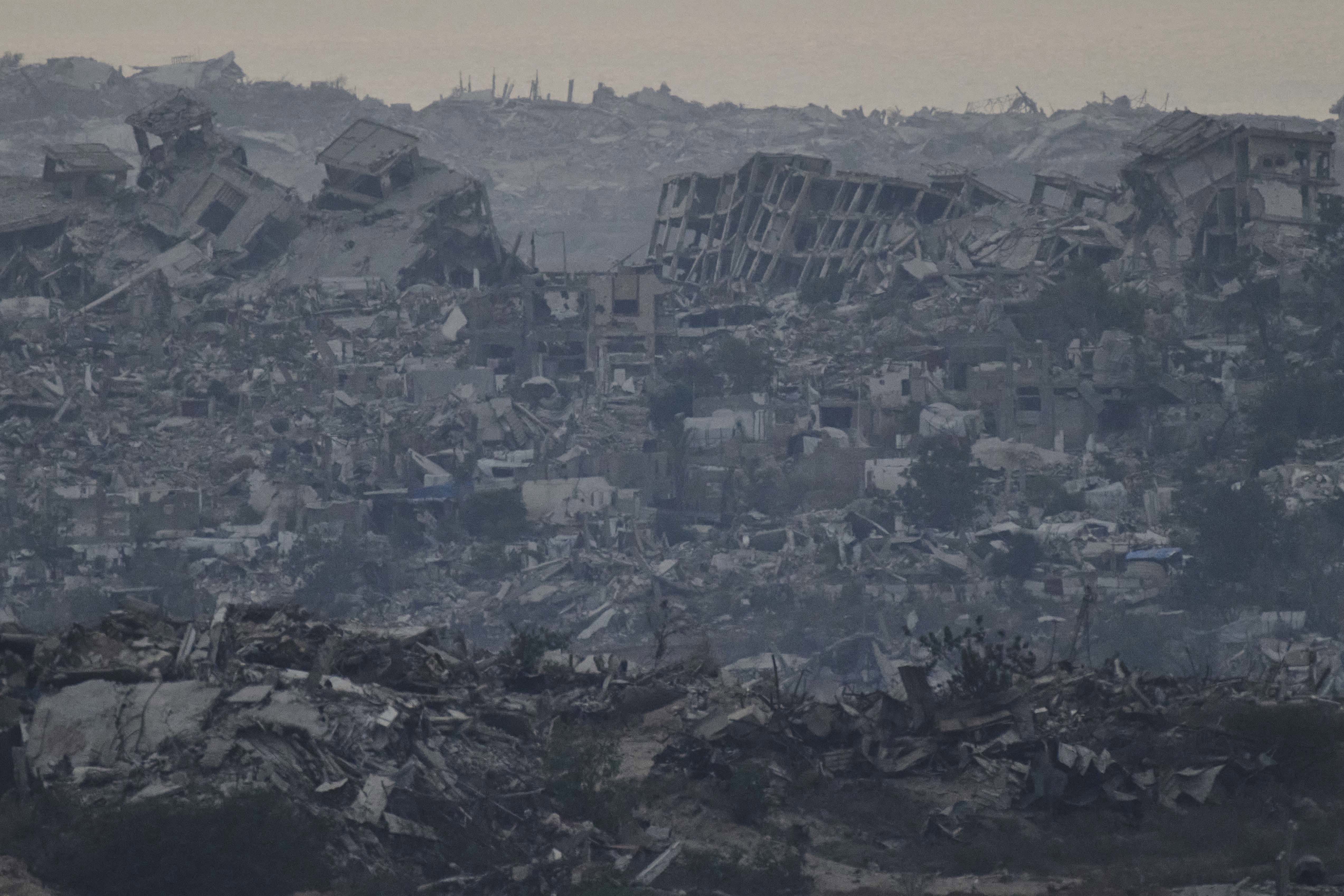 Buildings that were destroyed during the Israeli ground and air operations stand in the northern Gaza Strip as seen from southern Israel, Friday, Aug. 8, 2025. (AP Photo/Leo Correa)