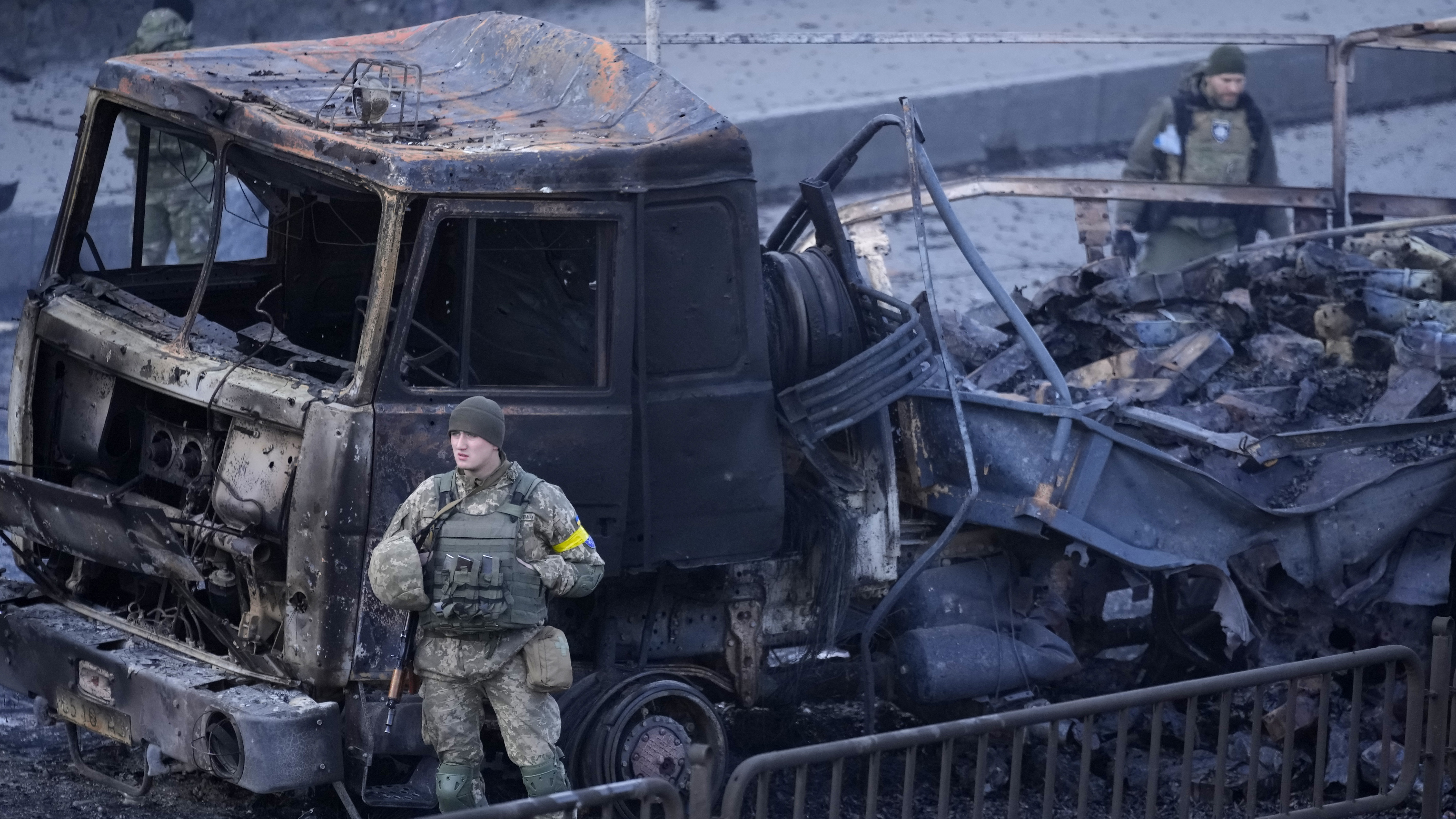 Ukrainian troops inspect the site following a Russian airstrike in Kyiv, Ukraine.