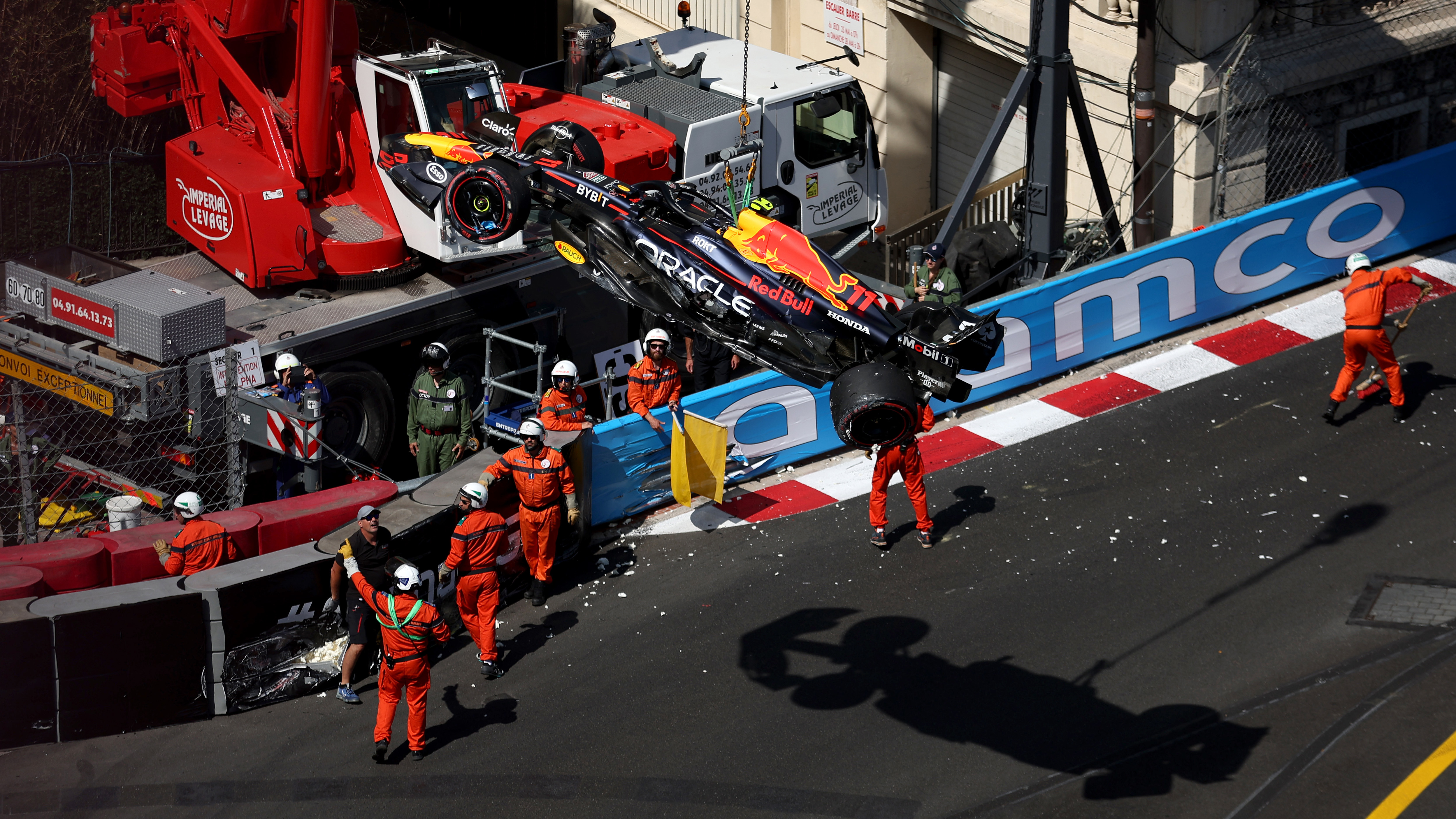 The car of Sergio Perez of Mexico and Oracle Red Bull Racing is removed from the circuit by a crane after he crashed during qualifying ahead of the F1 Grand Prix of Monaco at Circuit de Monaco on May 27, 2023 in Monte-Carlo, Monaco. (Photo by Bryn Lennon - Formula 1/Formula 1 via Getty Images)