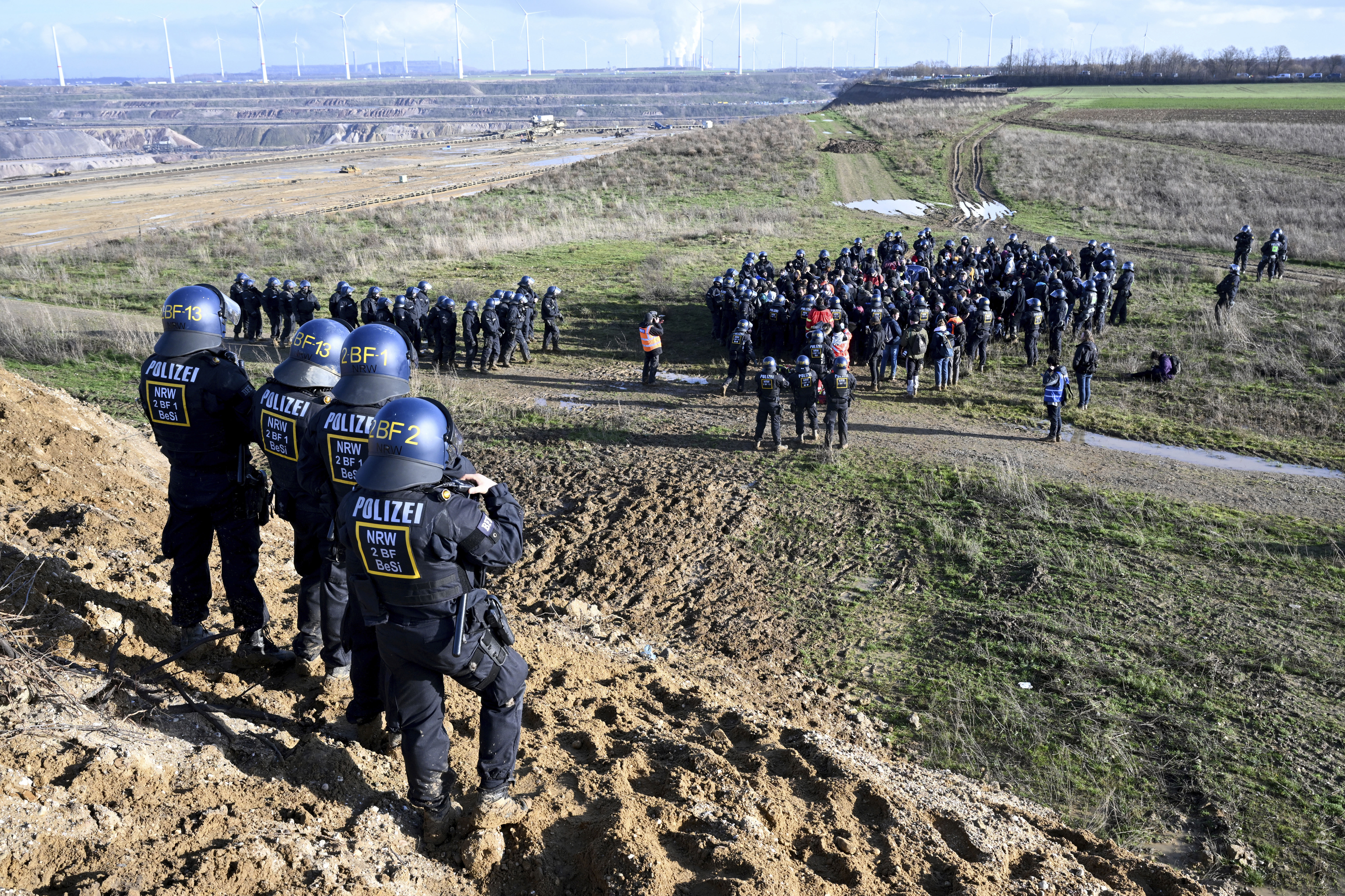 Police officers have surrounded a group of activists and coal opponents on the edge of the Garzweiler II lignite open pit mine during a protest by climate activists following the clearance of Luetzerath, Germany, Tuesday, Jan. 17, 2023. 