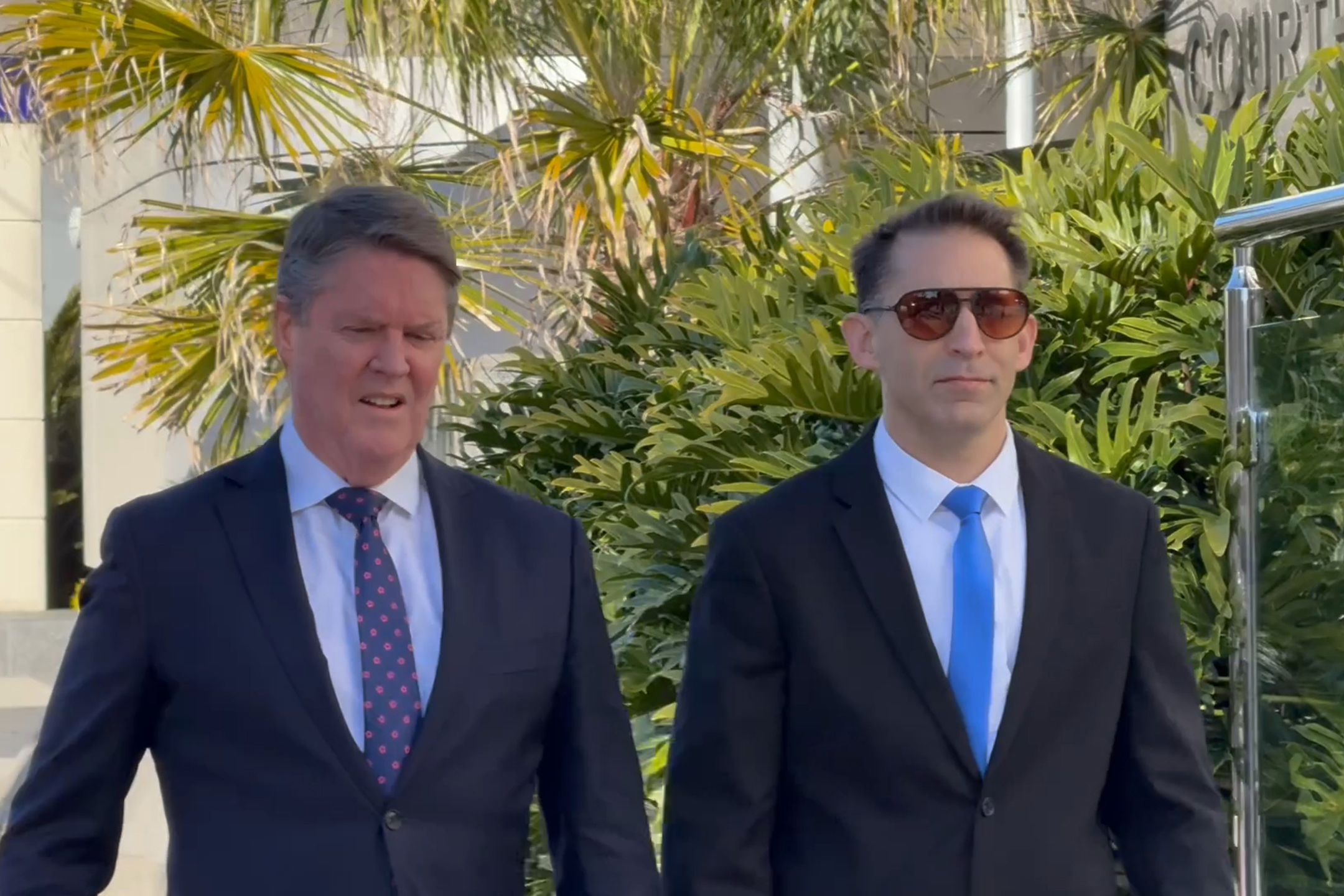In a video screenshot, Former Royal Australian Air Force pilot Robert John Crawford (right) arrives at Toowoomba Magistrates Court in Toowoomba, Monday, August 18, 2025.