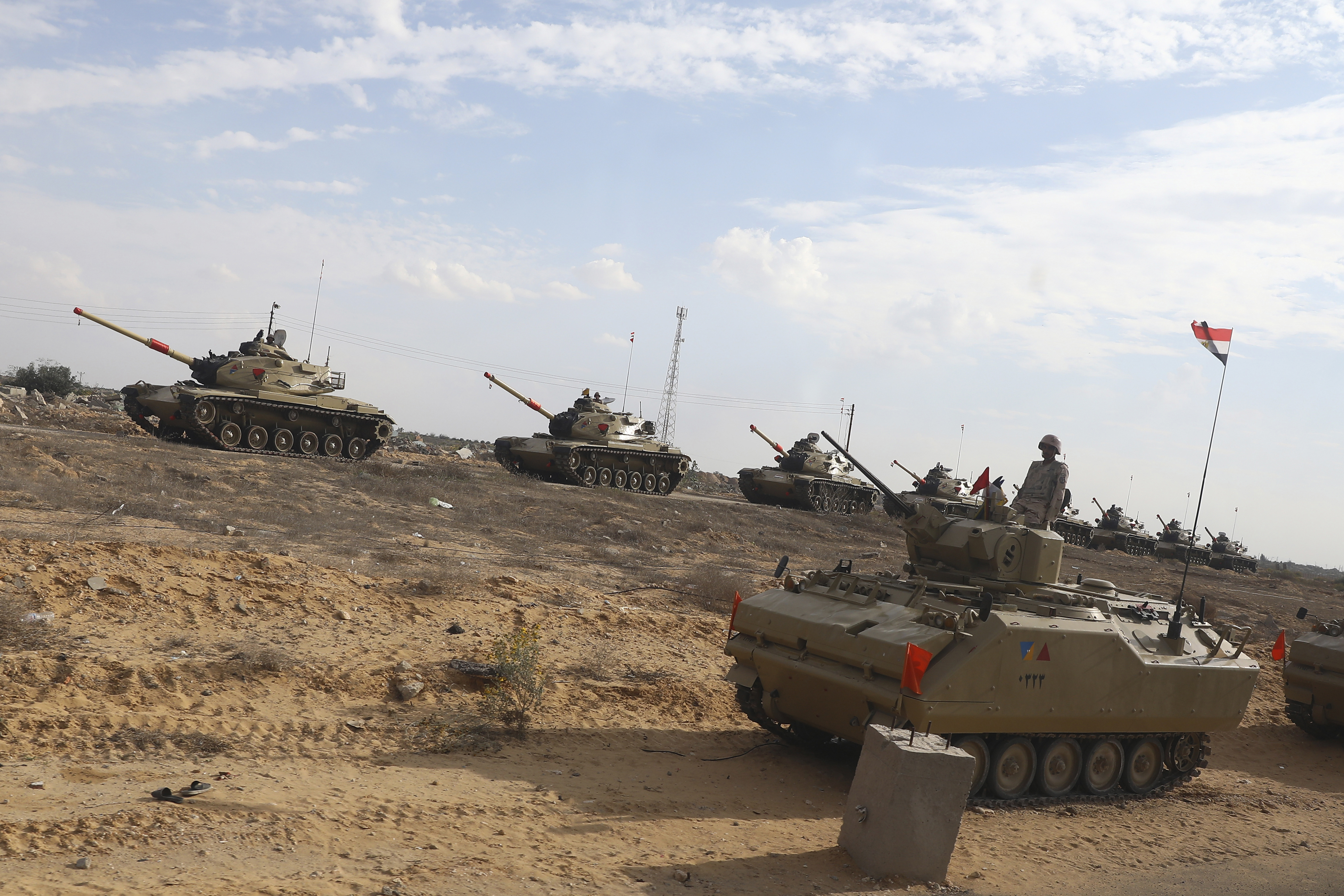 Egyptian military personnel stand alert on their tanks at the Rafah border crossing