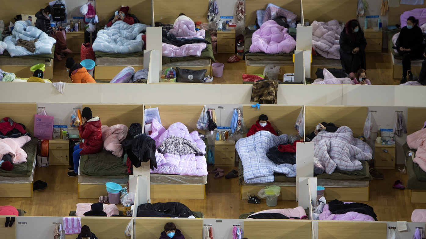 Patients infected with the coronavirus take rest at a temporary hospital converted from Wuhan Sports Centre in Wuhan.