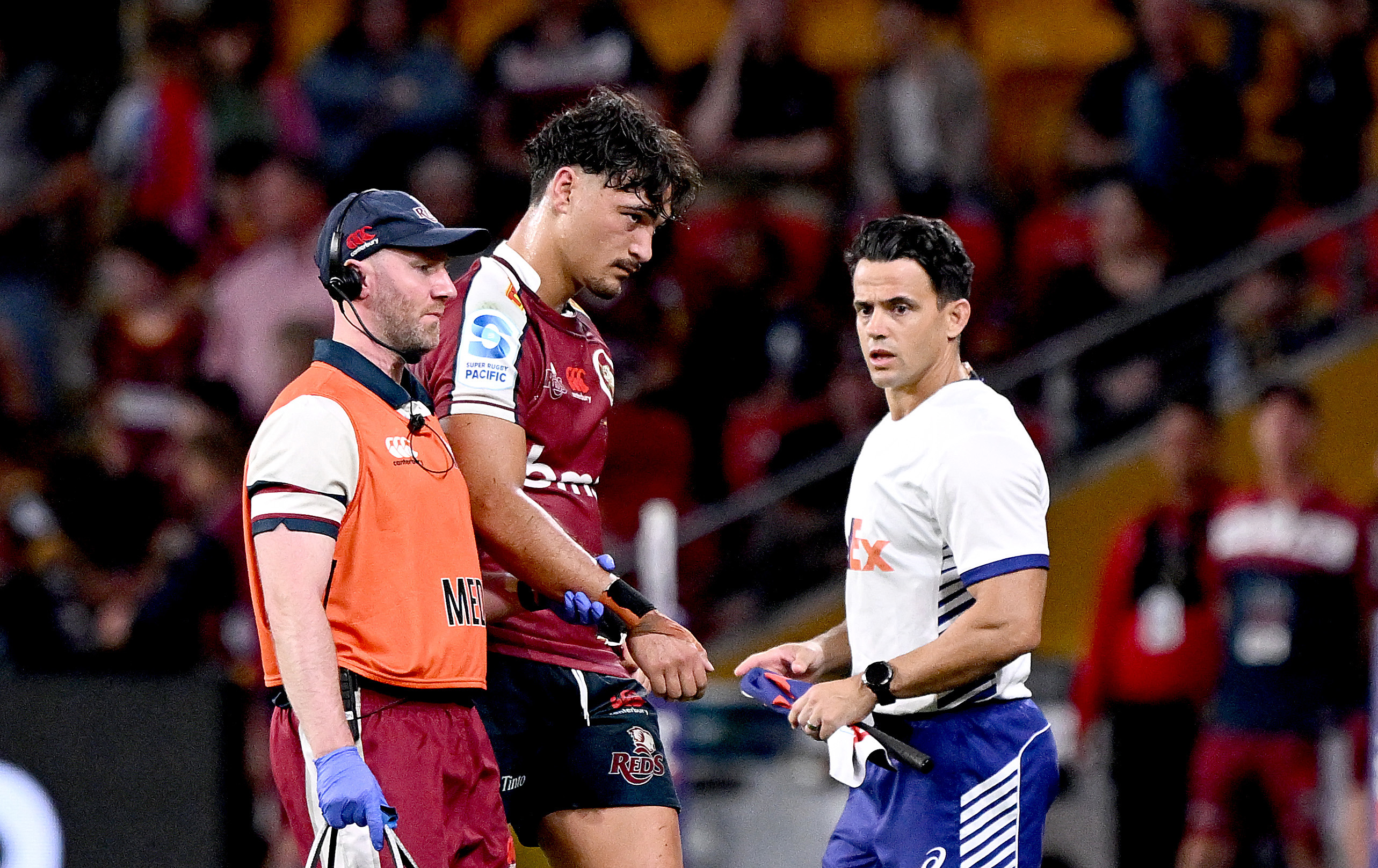 Jordan Petaia of the Reds is taken from the field injured during the round nine Super Rugby Pacific match against the Highlanders.