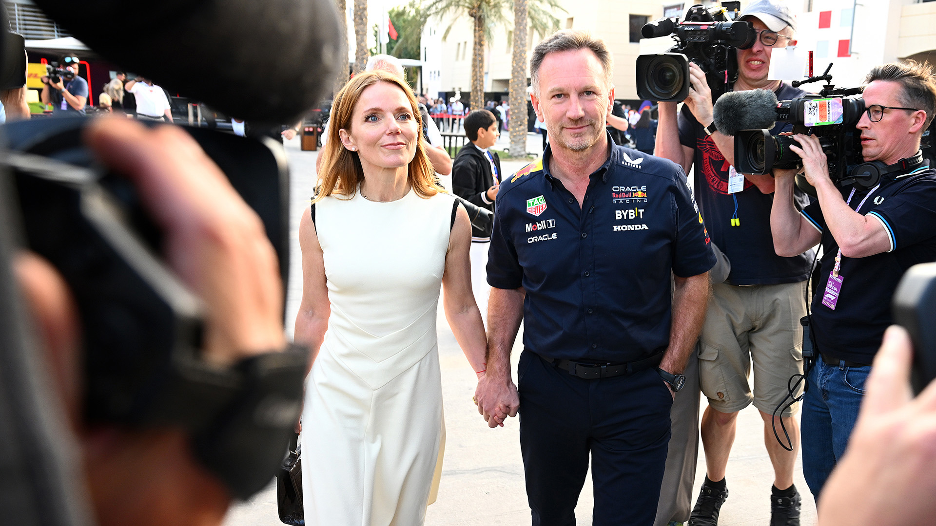 Red Bull Racing team principal Christian Horner (right) and Geri Horner walk in the paddock holding hands prior to the F1 Grand Prix of Bahrain.