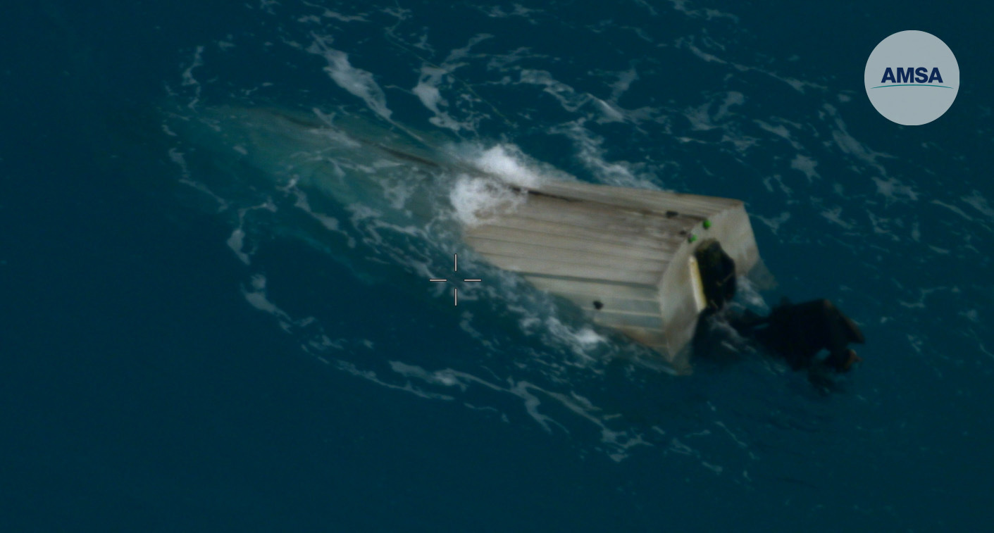 The man's dinghy was swamped by waves.