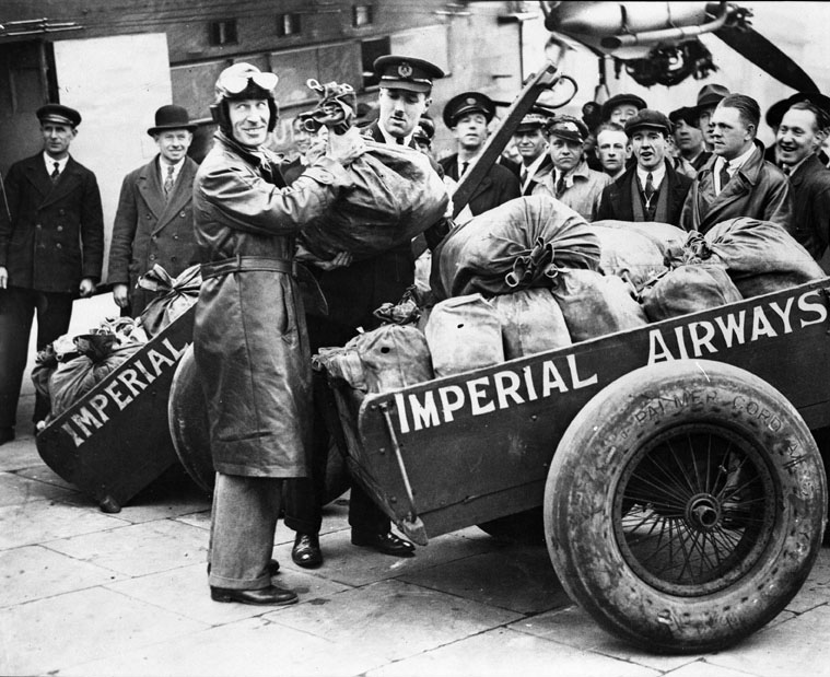 Charles Kingsford Smith on arrival at Croydon, England, with some of the fifty thousand letters of the first Christmas airmail from Australia to England, 1931