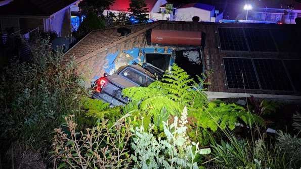 The ute crashed into the roof of the home in Port Macquarie.