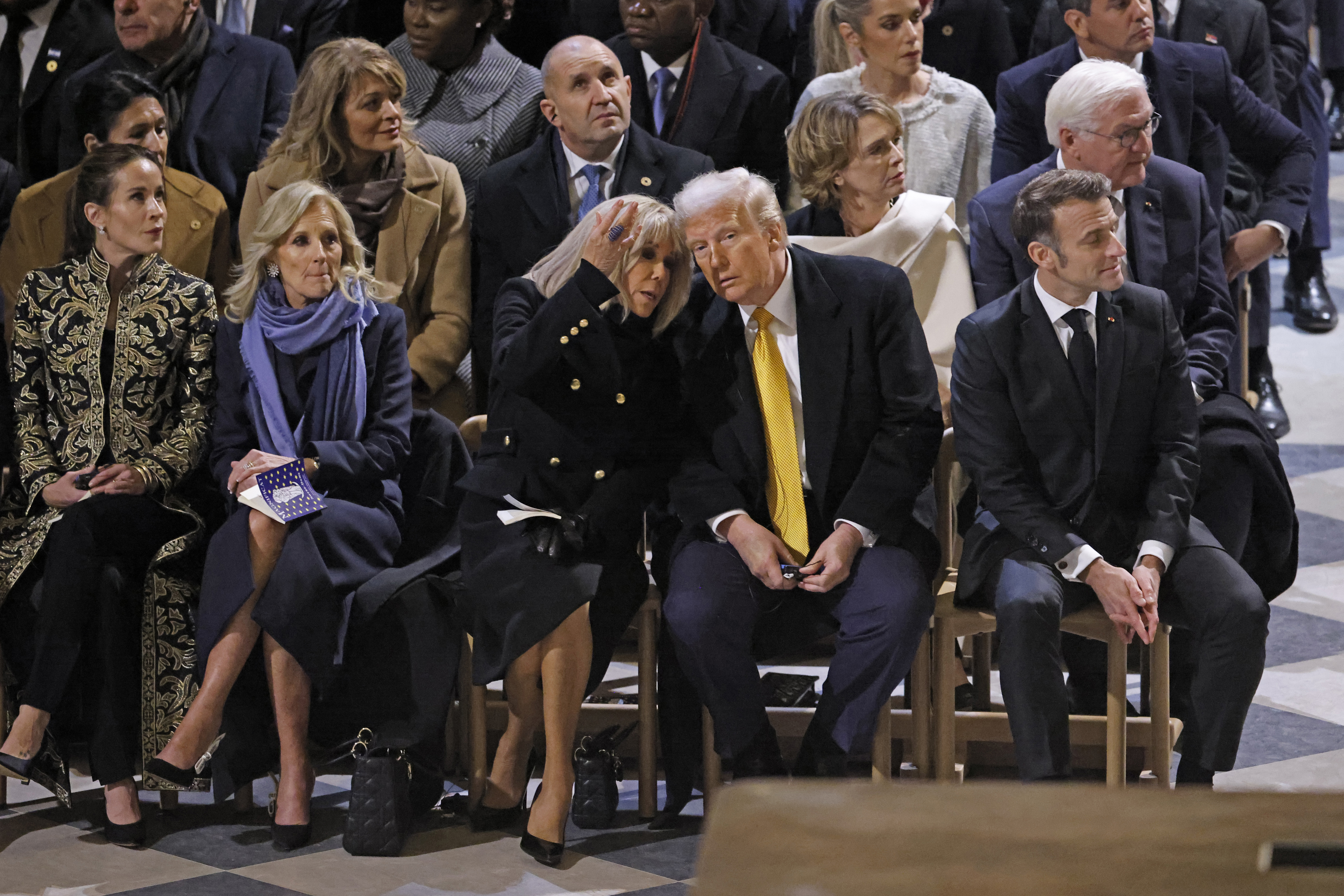 President Emmanuel Macron's wife Brigitte Macron talks with US President-elect Donald Trump as they sit alongside daughter of US President Joe Biden, Ashley Biden, left, First Lady Jill Biden, second left, and French President Emmanuel Macron in Notre Dame Cathedral as France's iconic cathedral is formally reopening its doors for the first time since a devastating fire nearly destroyed the 861-year-old landmark in 2019, Saturday Dec.7, 2024 in Paris ( Ludovic Marin, Pool via AP)