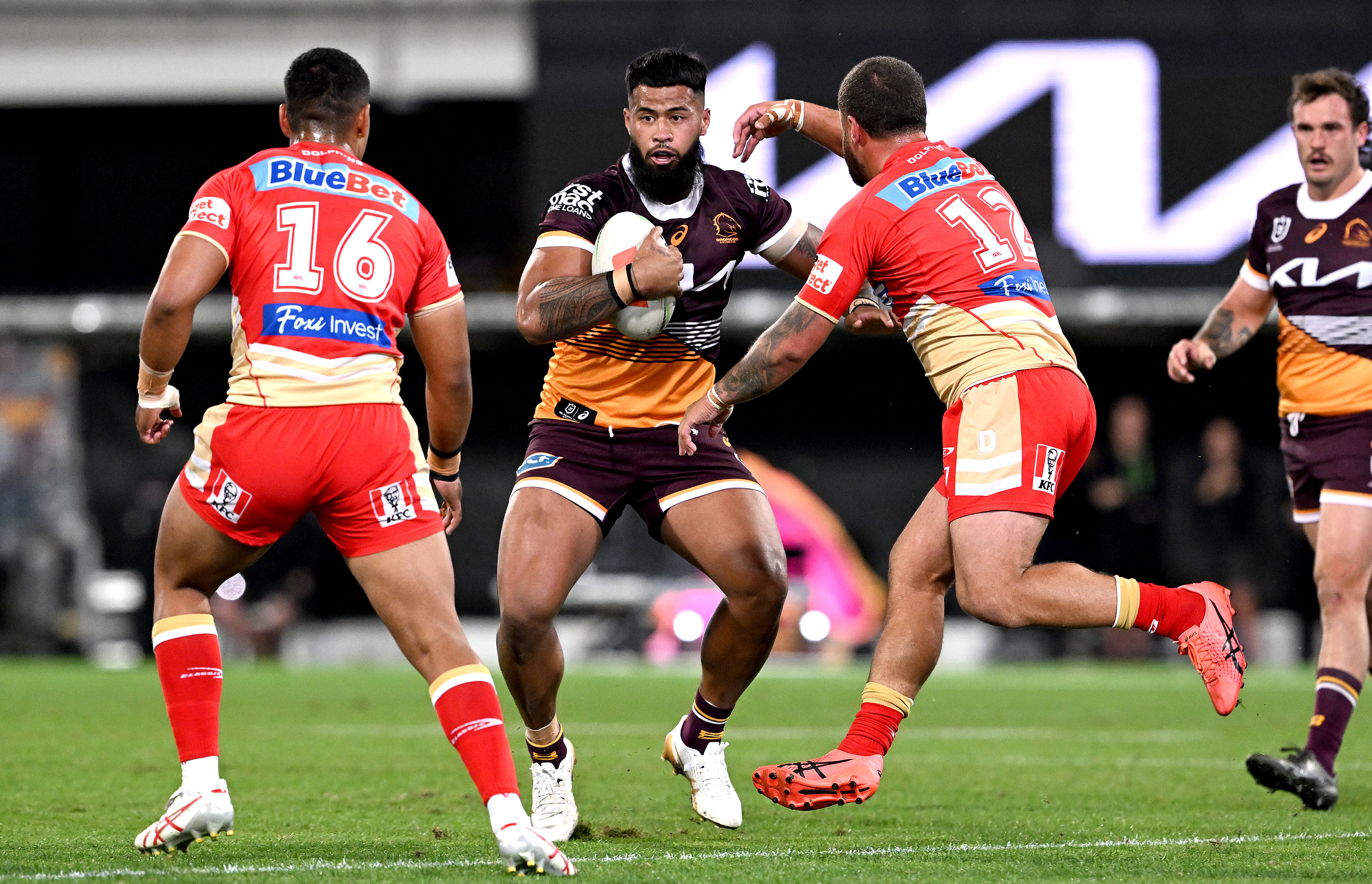 Payne Haas of the Broncos takes on the Dolphins defence.