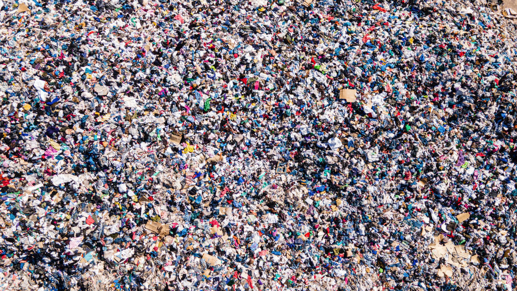 25 November 2021, Chile, Alto Hospicio: Used clothes sit in a landfill in the desert. In the nearby free trade zone of Iquique, 29,178 tons of used clothing arrived in 2021 through October. About 50 importers sell the best pieces from them, while the others - an estimated 40 percent - sort them out. (to dpa "Chile's Atacama Desert: Graveyard for Used Clothes") Photo: Antonio Cossio/dpa (Photo by Antonio Cossio/picture alliance via Getty Images)