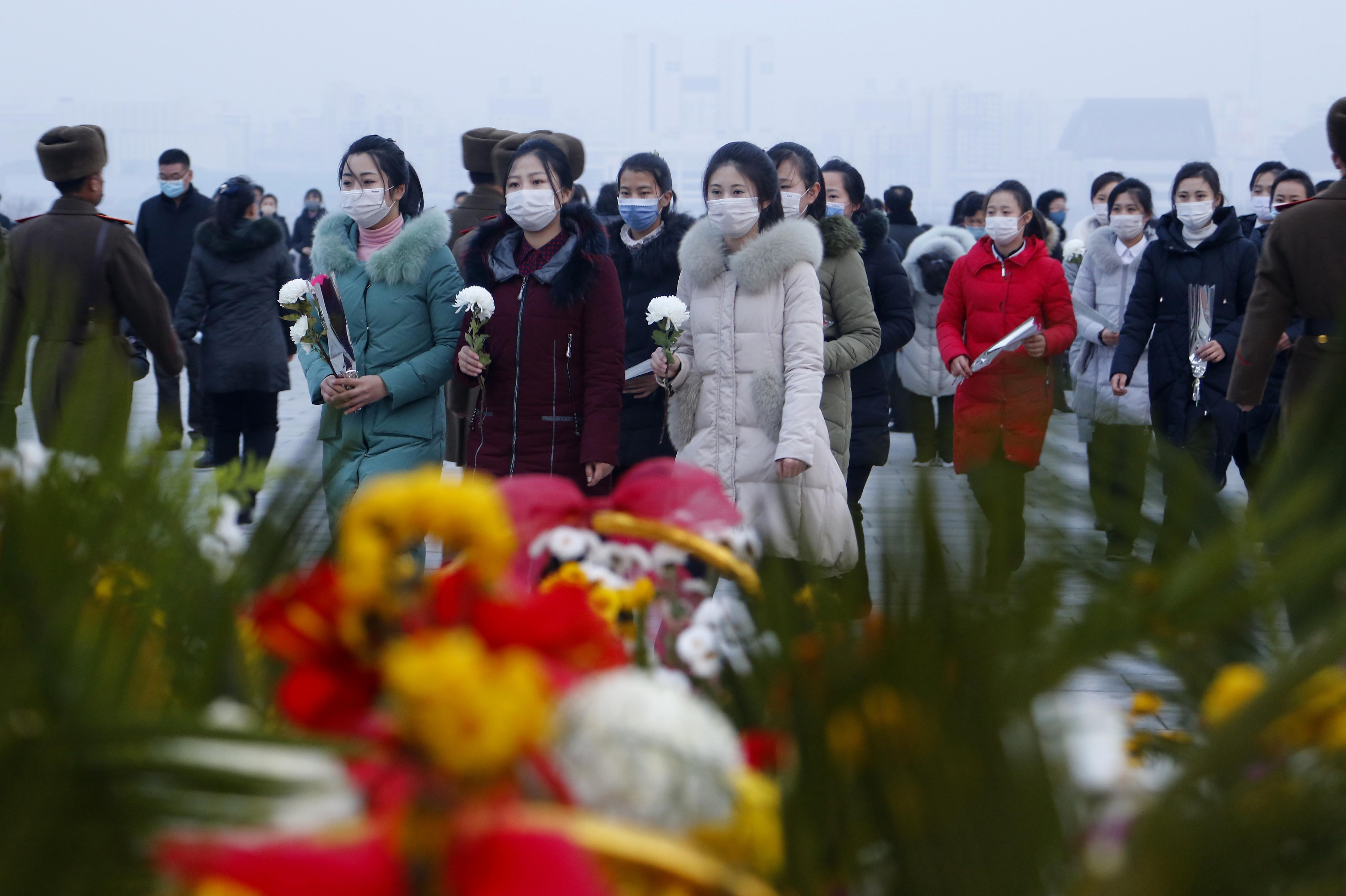 Citizens visit the statues of President Kim Il Sung and Chairman Kim Jong Il on Mansu Hill