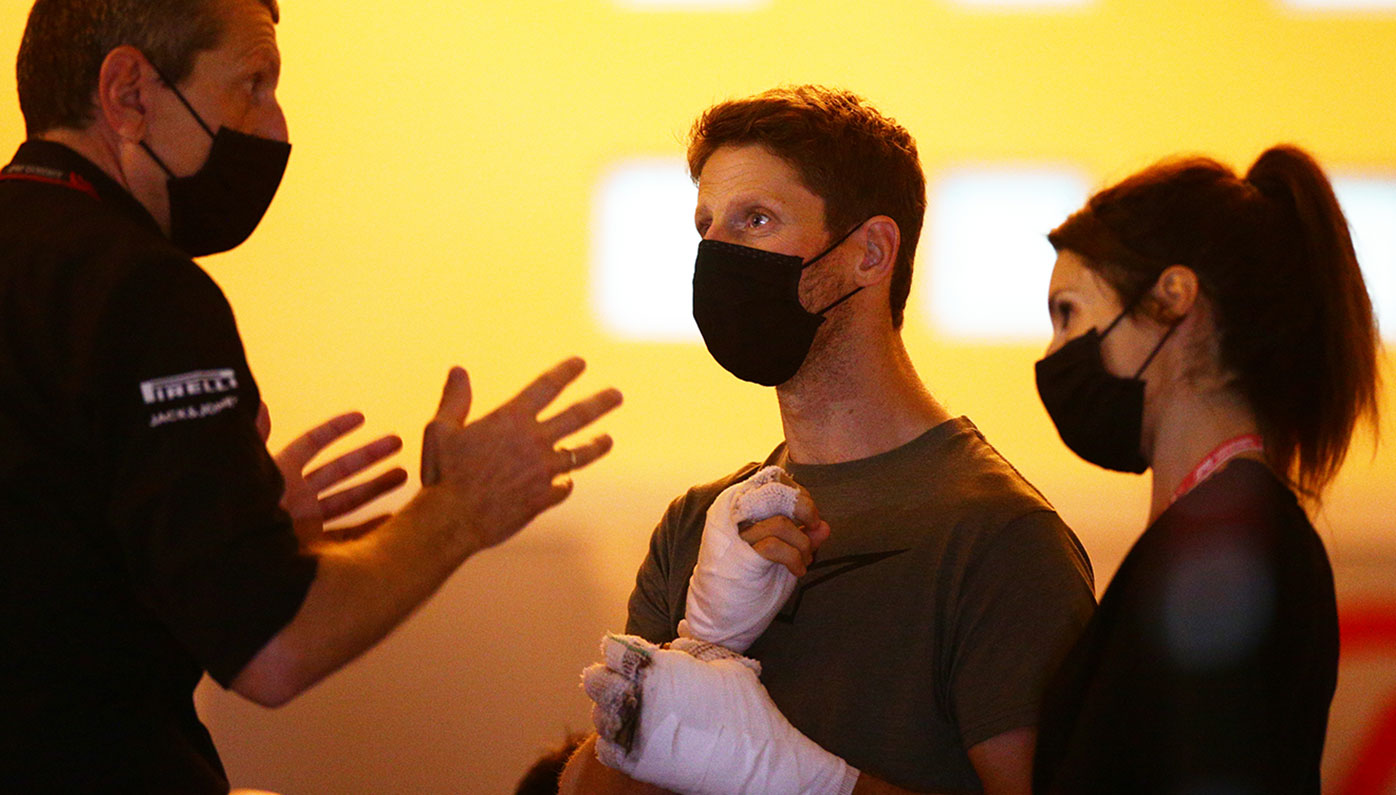 Romain Grosjean and his wife Marion meet with Haas team boss Gunther Steiner.