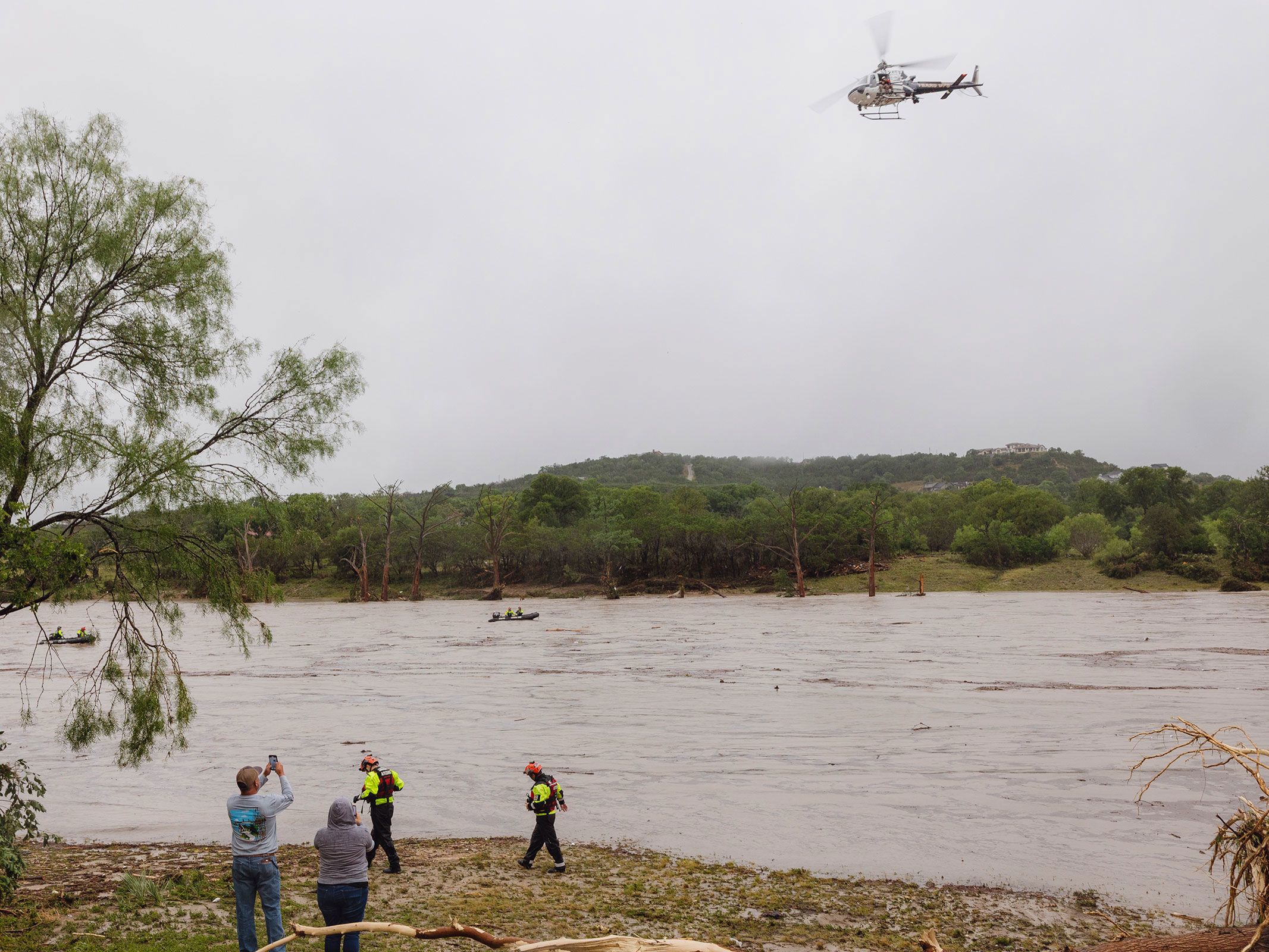 A Texas DPS helicopter conducts arial searches along the Guadalupe River in Kerrville on July 4.